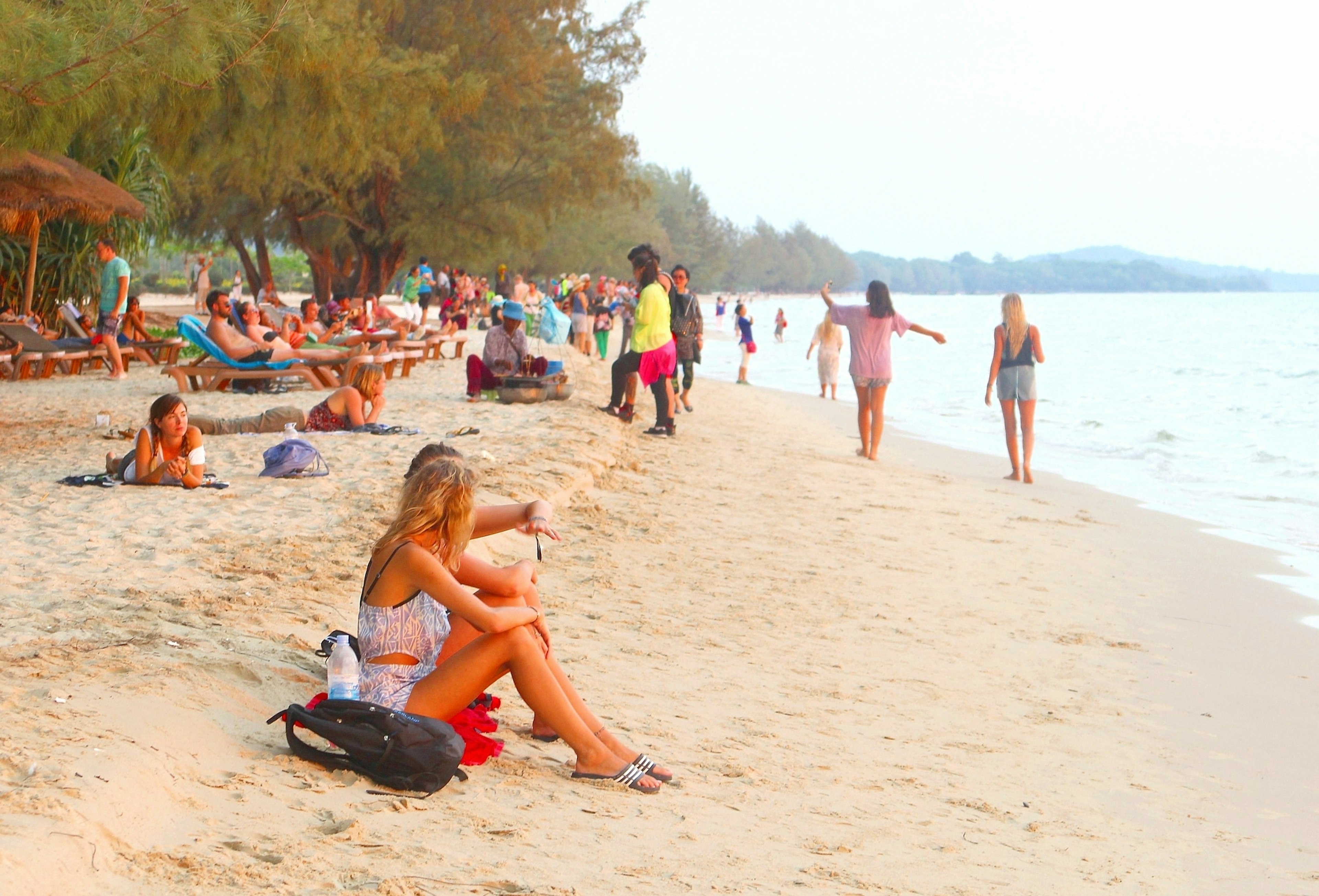 SIHANOUKVILLE, CAMBODIA, ASIA - March 27, 2017. Young western women and other people are chilling and relaxing at white sandy Otres beach just before sunset, holiday vacation along the ocean.  License Type: media  Download Time: 2023-08-01T14:10:00.000Z  User: FergalCo  Is Editorial: Yes  purchase_order: