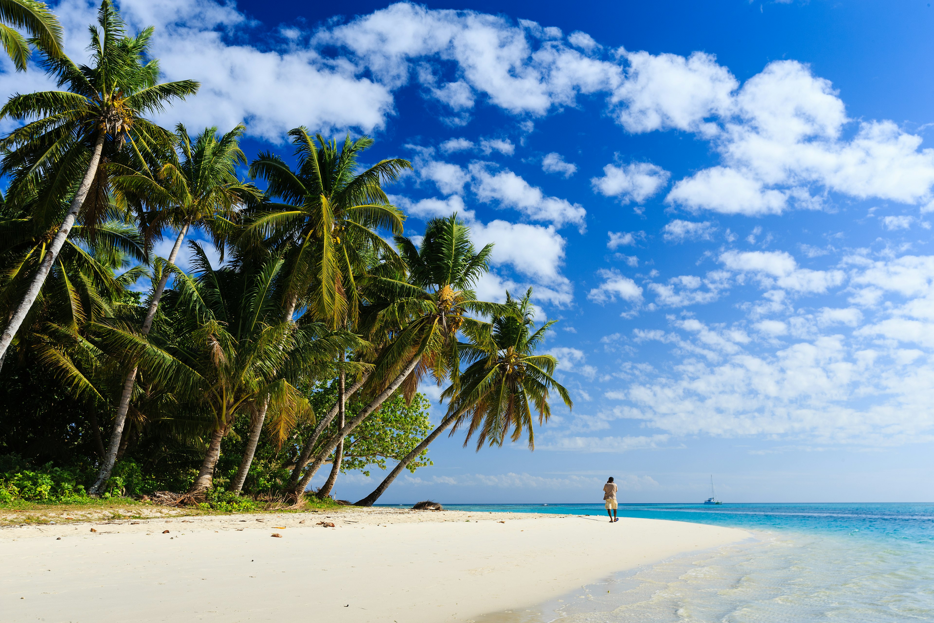 A person walking on the beach at Ile Aux Nattes near Ile Sainte-Marie, Madagascar.