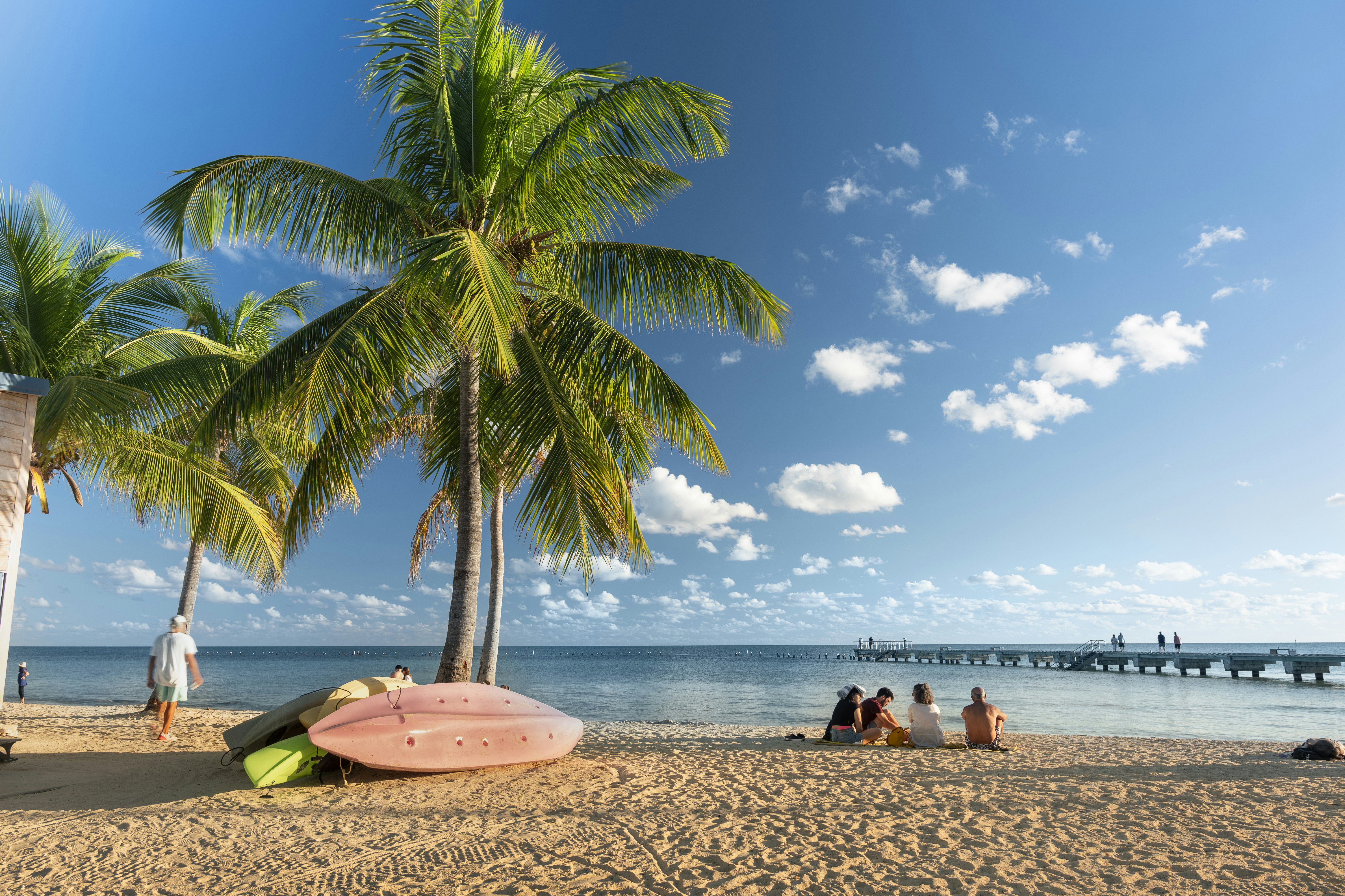 People gather on the sand of Smathers Beach to watch the sunset in Key West, Florida.