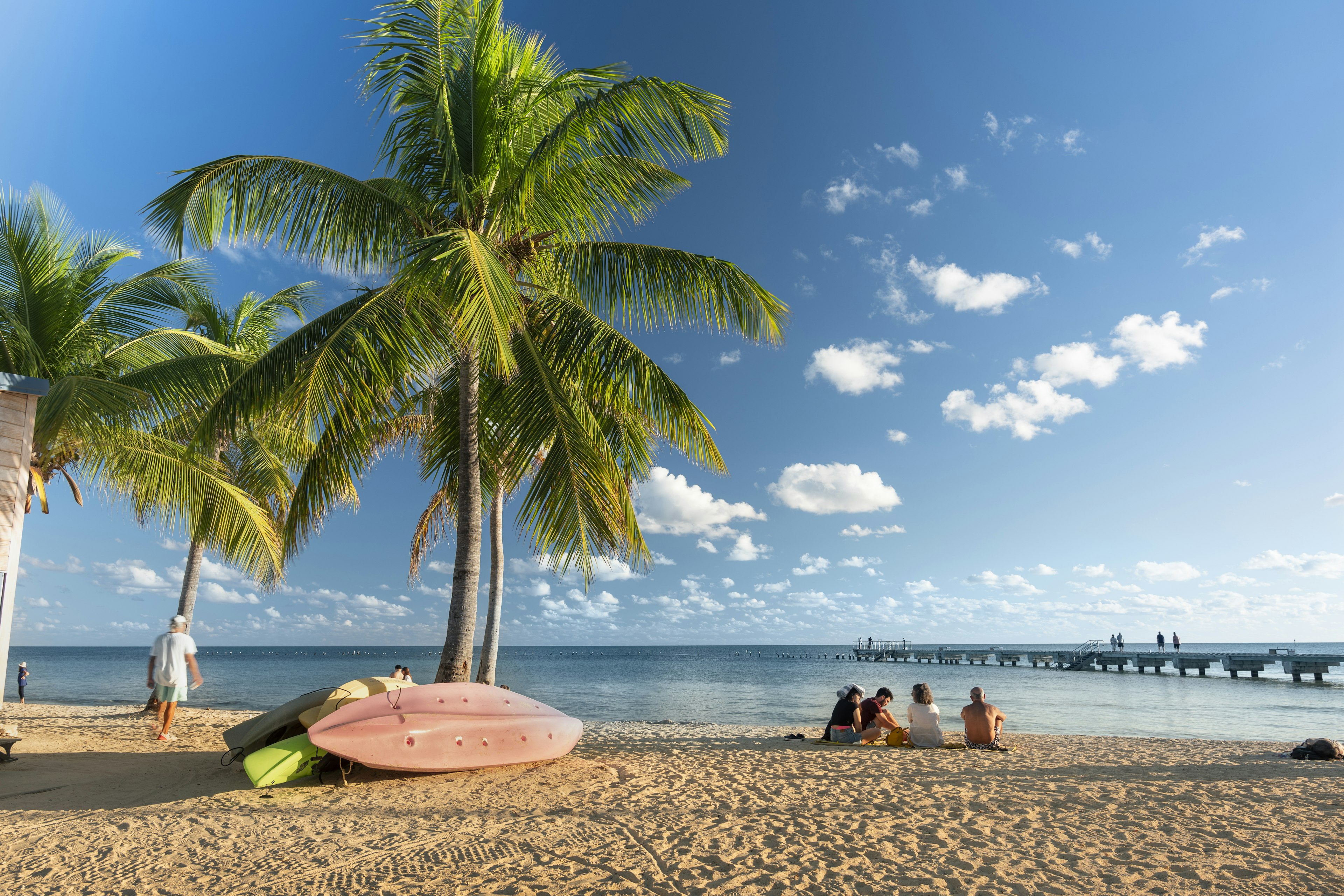 People gather on the sand of Smathers Beach to watch the sunset in Key West, Florida.