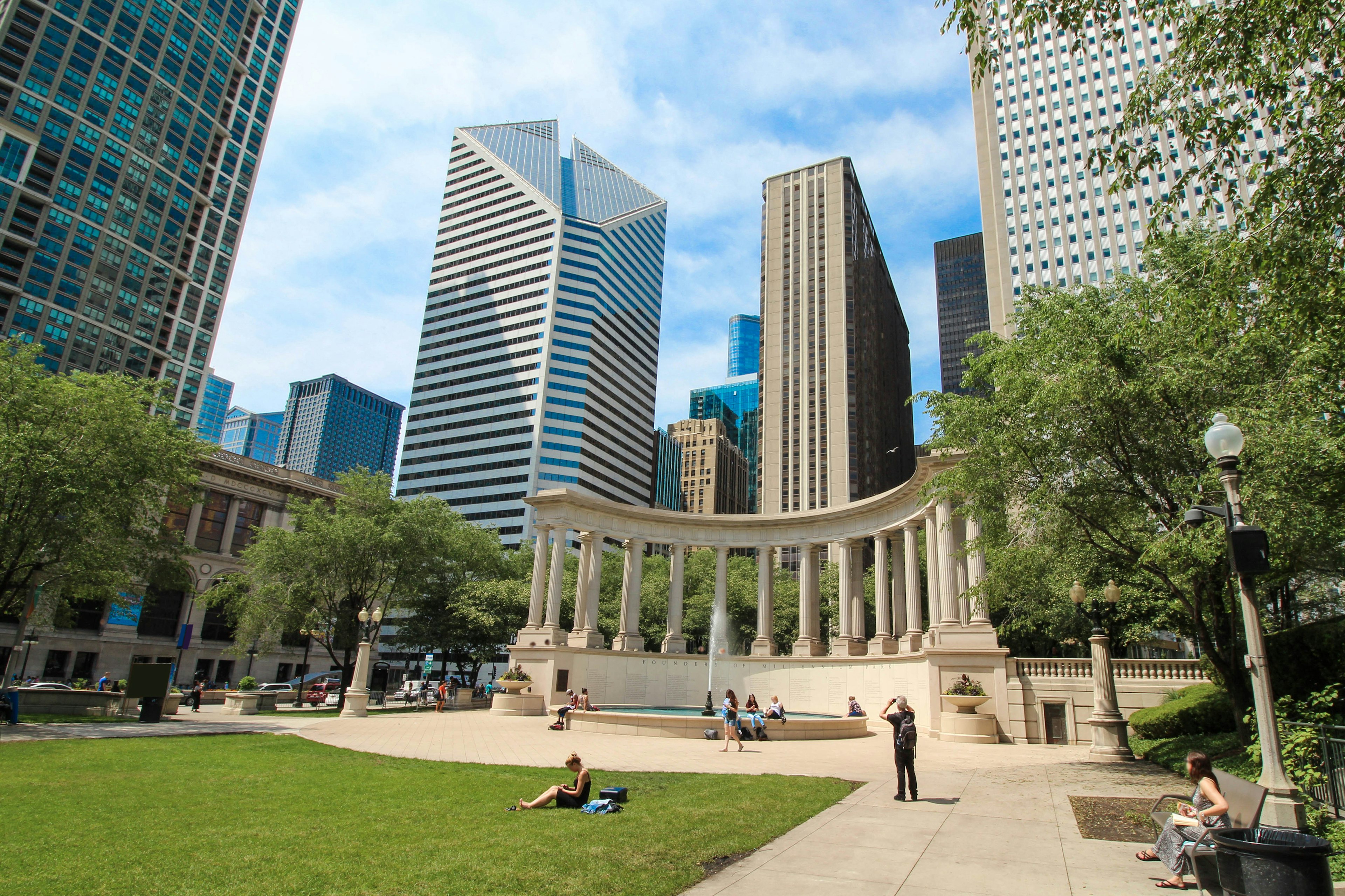 People sunbathing near the Millennium Monument in Millennium Park, Chicago.