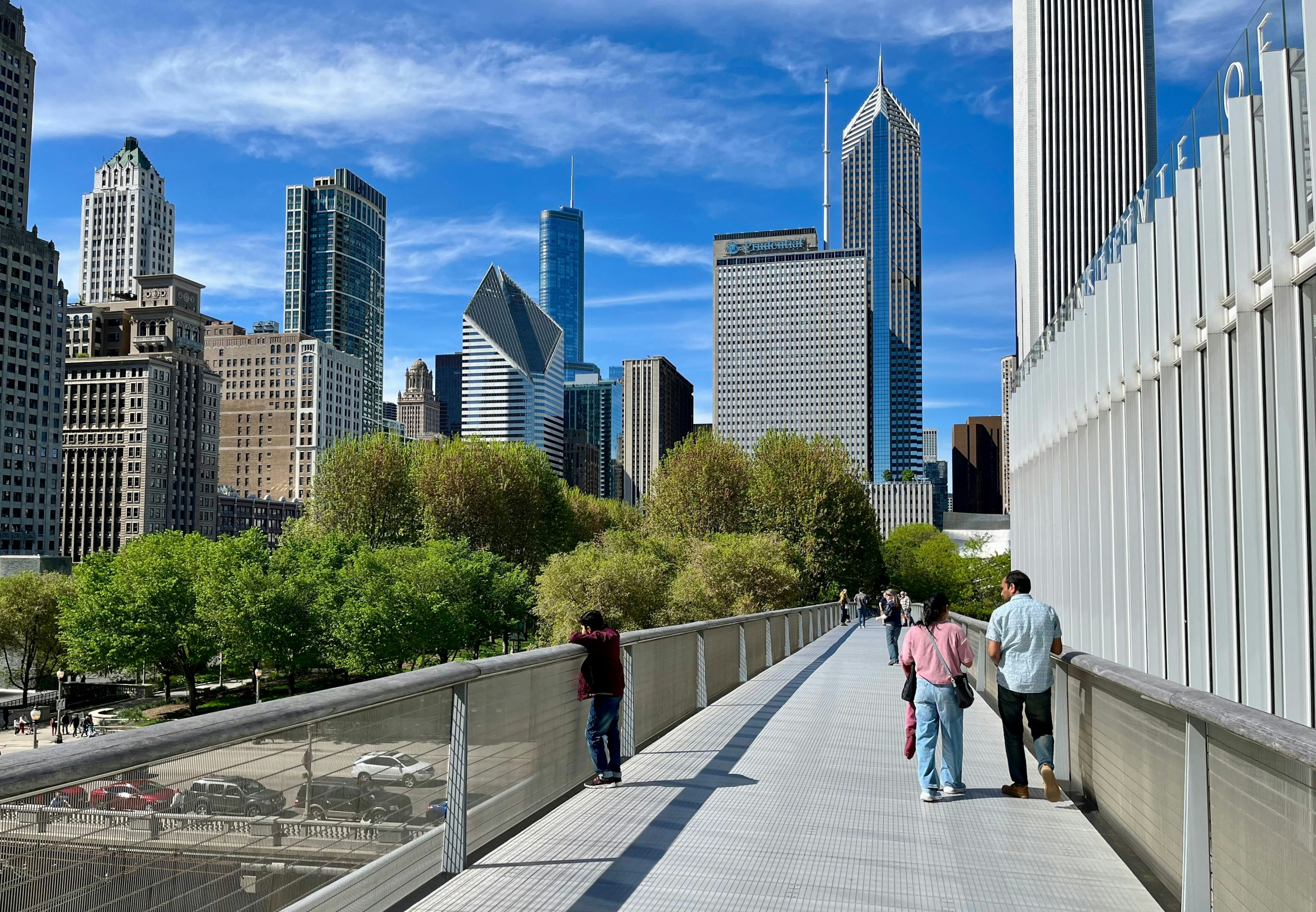 People walking over Nichols Bridgeway in Millennium Park, Chicago.