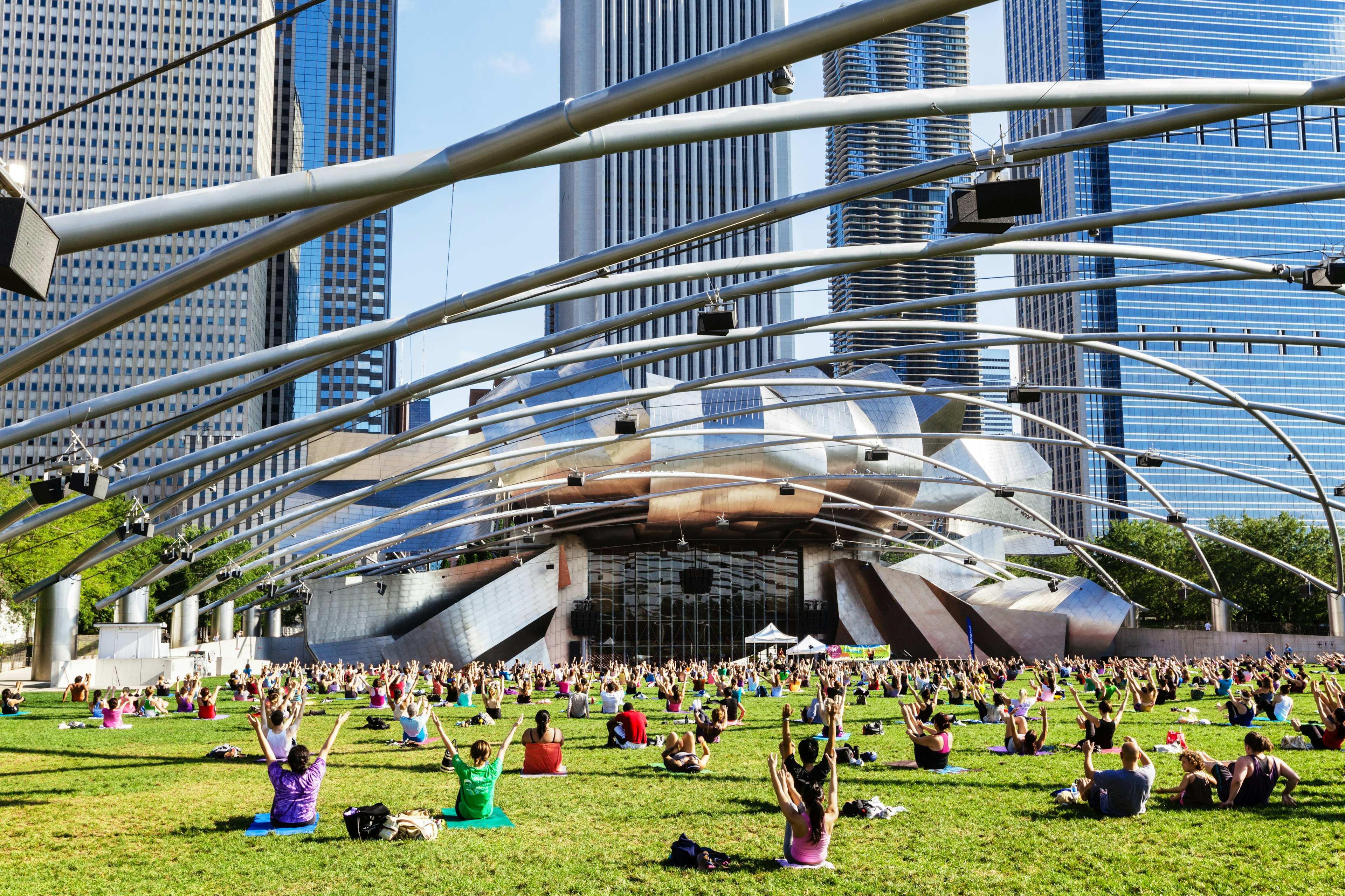 People doing an exercise class in front of the Jay Pritzker Pavilion, Chicago.