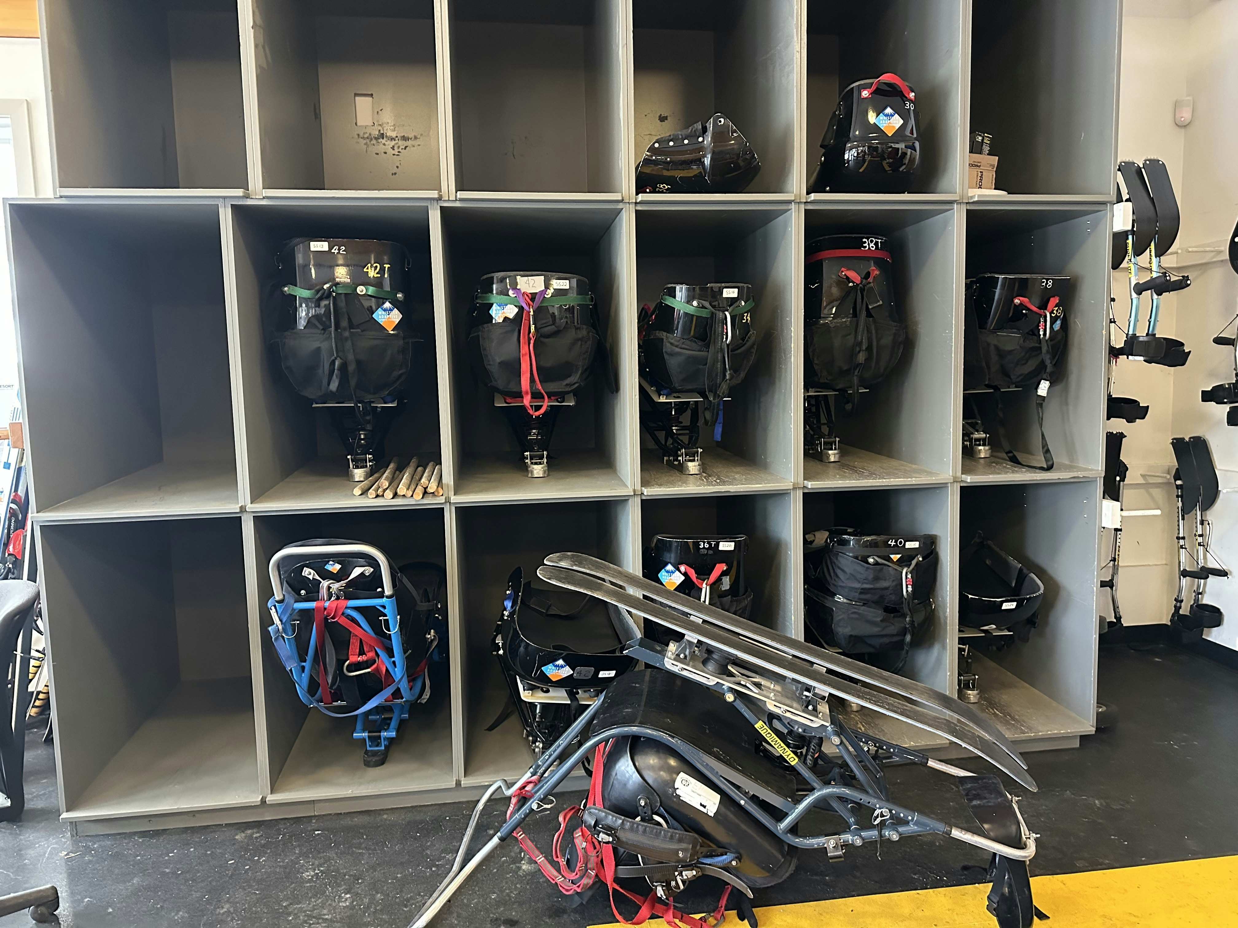 The collection of different sit skis available to those seeking accessible skiing at Whistler Blackcomb.