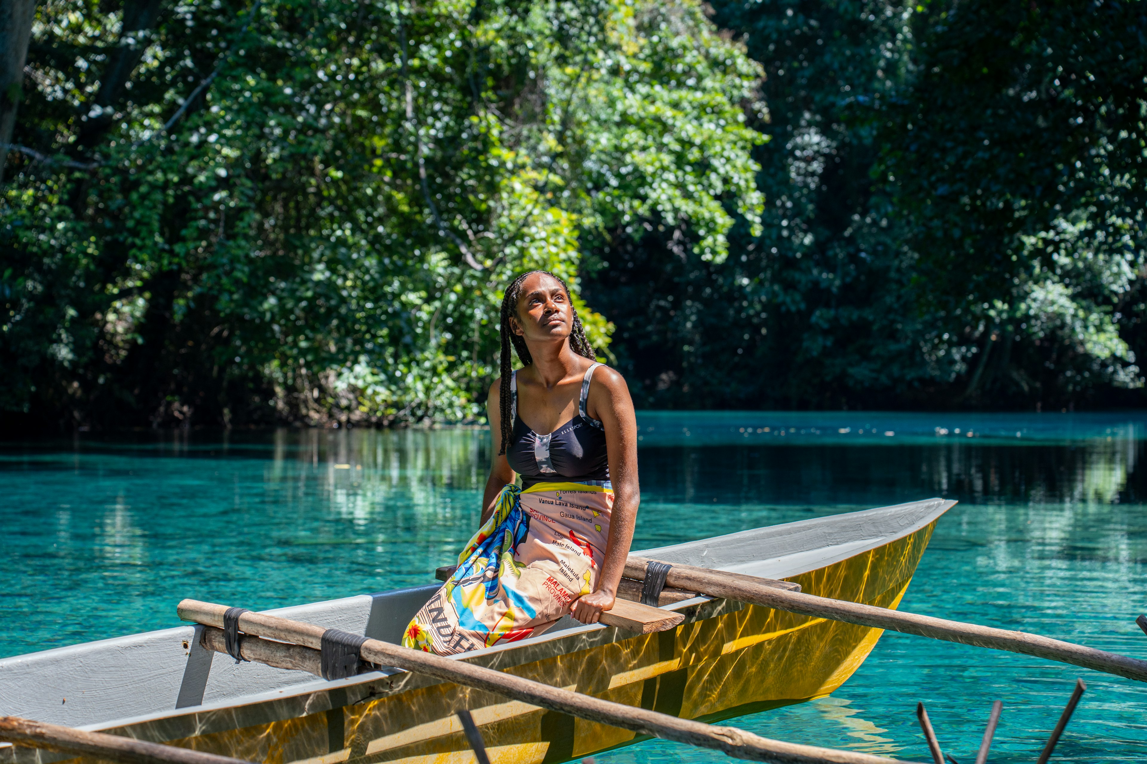 Female tourist on a canoe tour in the Riri River.