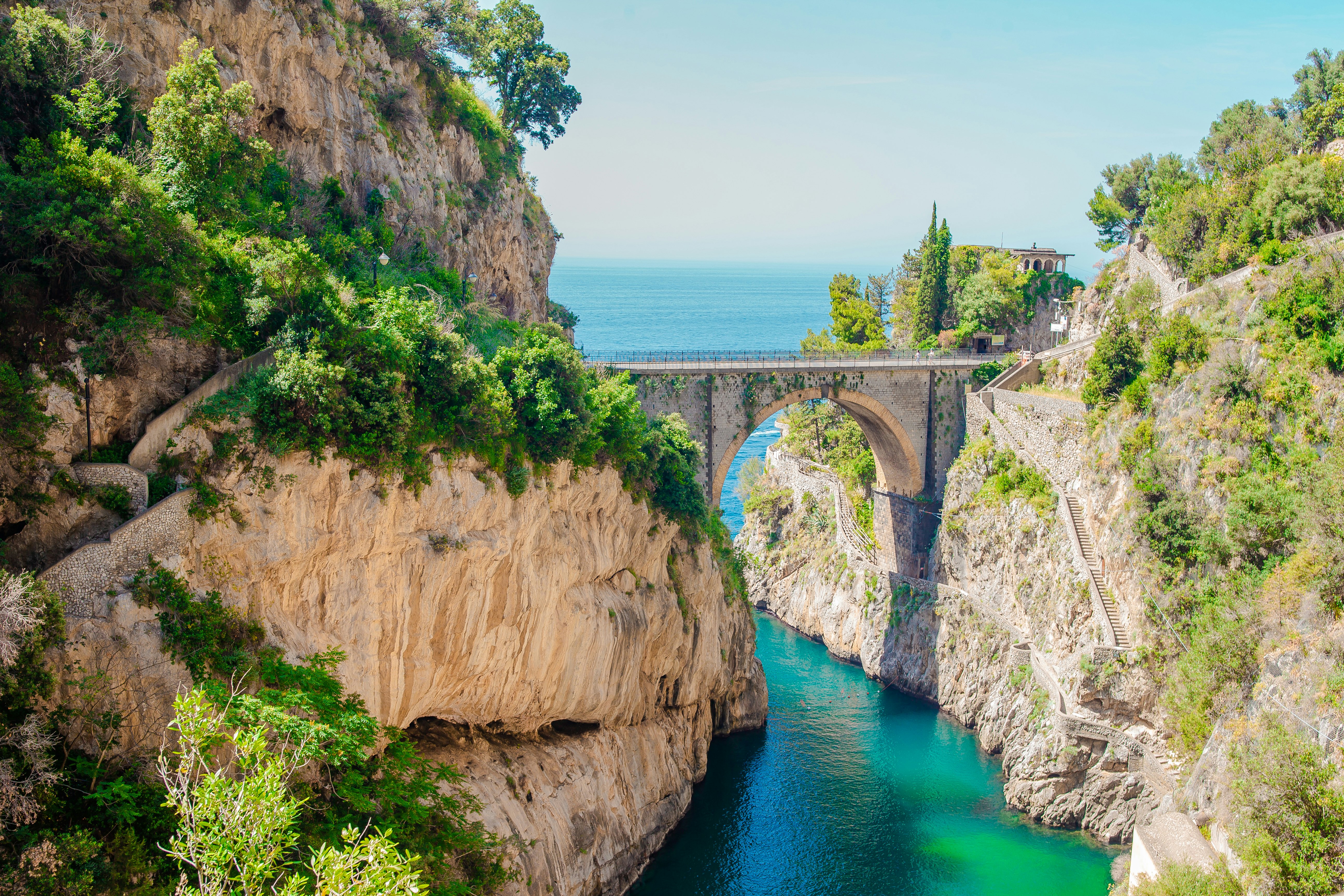 Fiordo di Furore seen from bridge, with rocks, water, sky and greenery