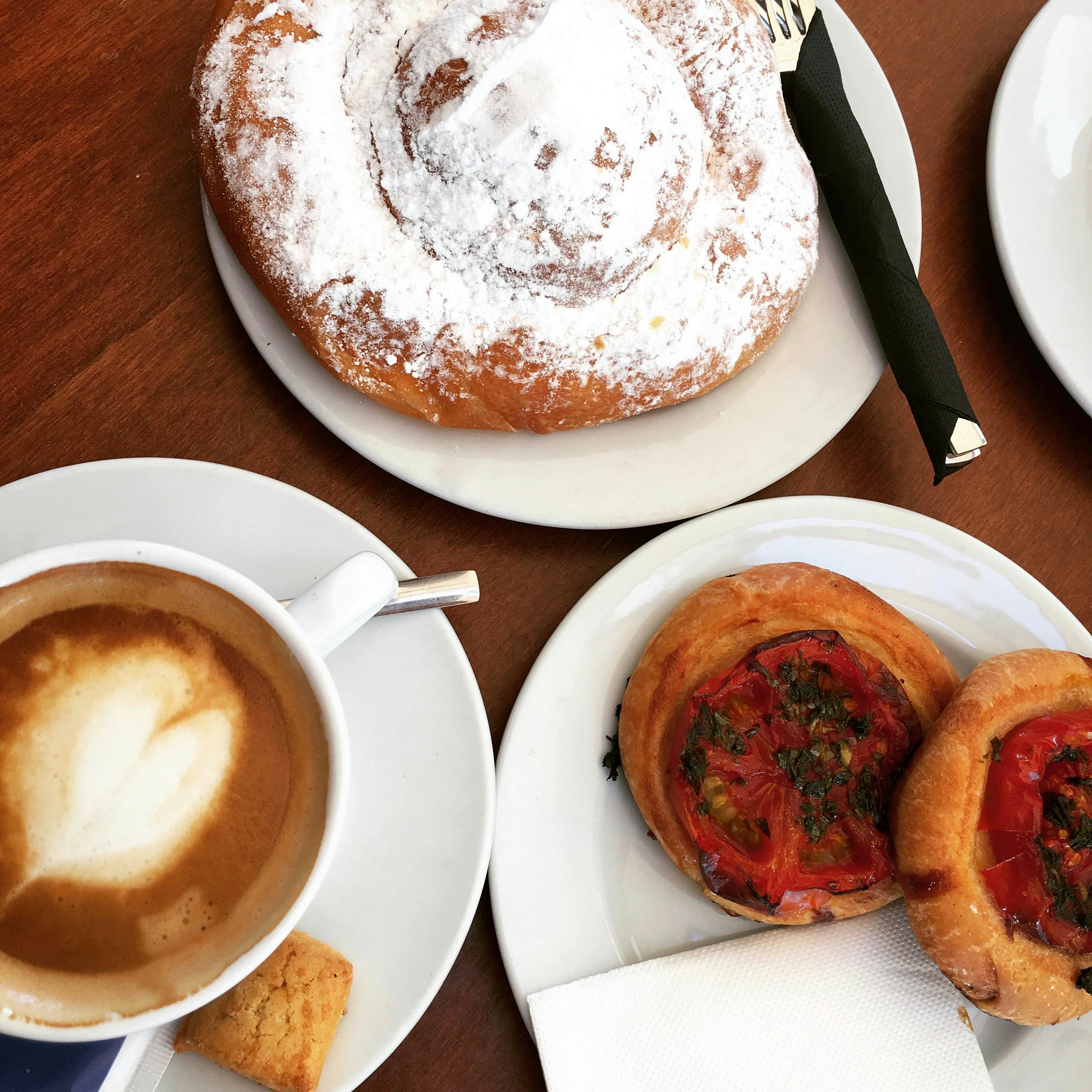Coffee, tomato tarts and an ensaimada dusted with powdered sugar 