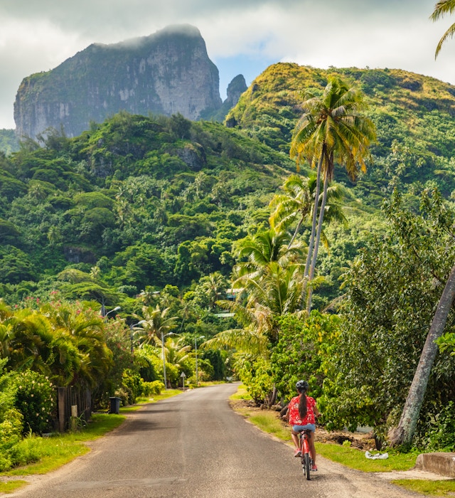Biking tourist on summer vacation travel discovering by e-bike cycling through forest of Bora Bora island in Tahiti, French Polynesia., License Type: media, Download Time: 2025-01-21T19:03:49.000Z, User: tasminwaby56, Editorial: false, purchase_order: 65050 - Digital Destinations and Articles, job: Online Editorial, client: Tahiti on a budget, other: Tasmin Waby