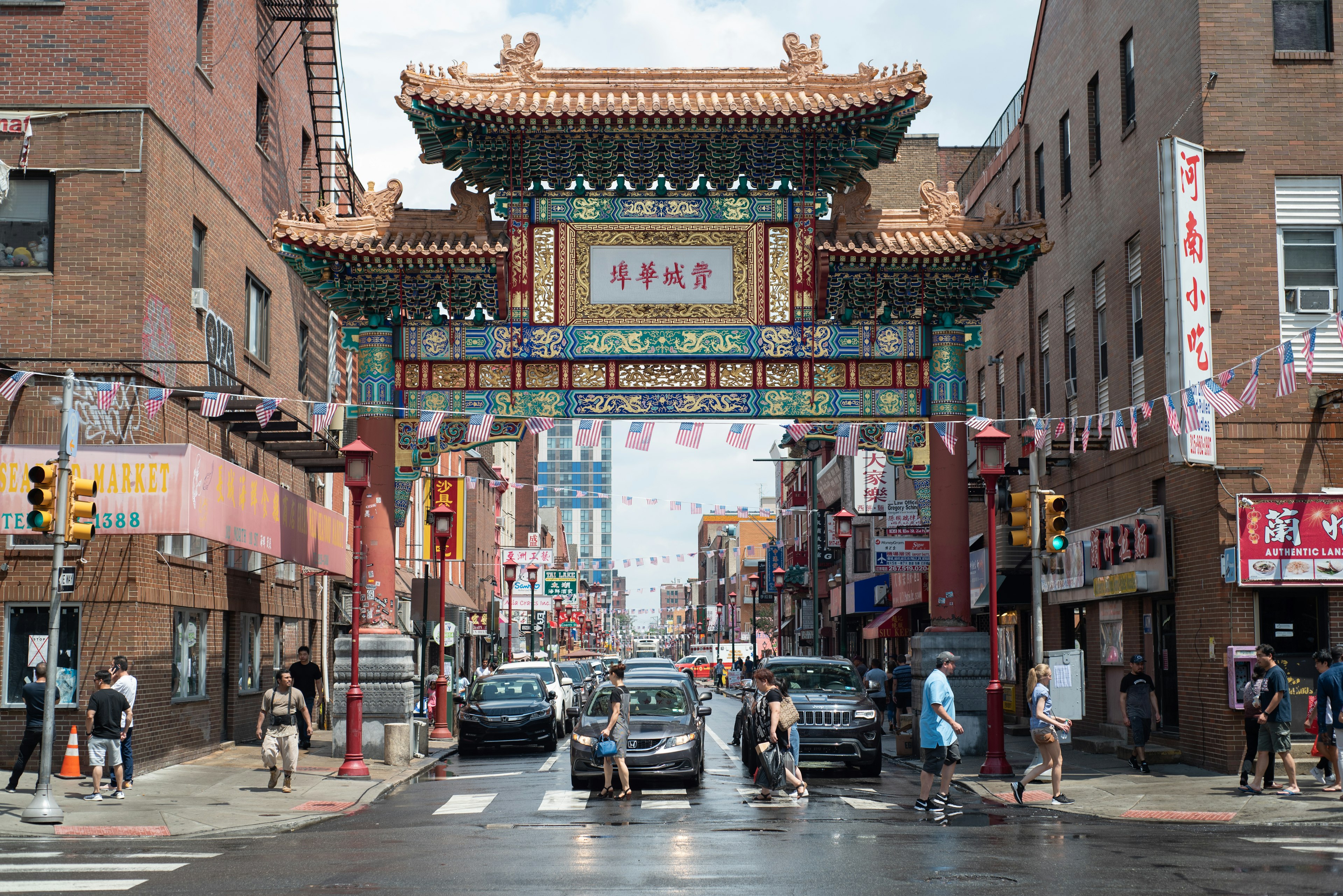 Chinatown Friendship Gate and passersby in Philadelphia, Pennsylvania.