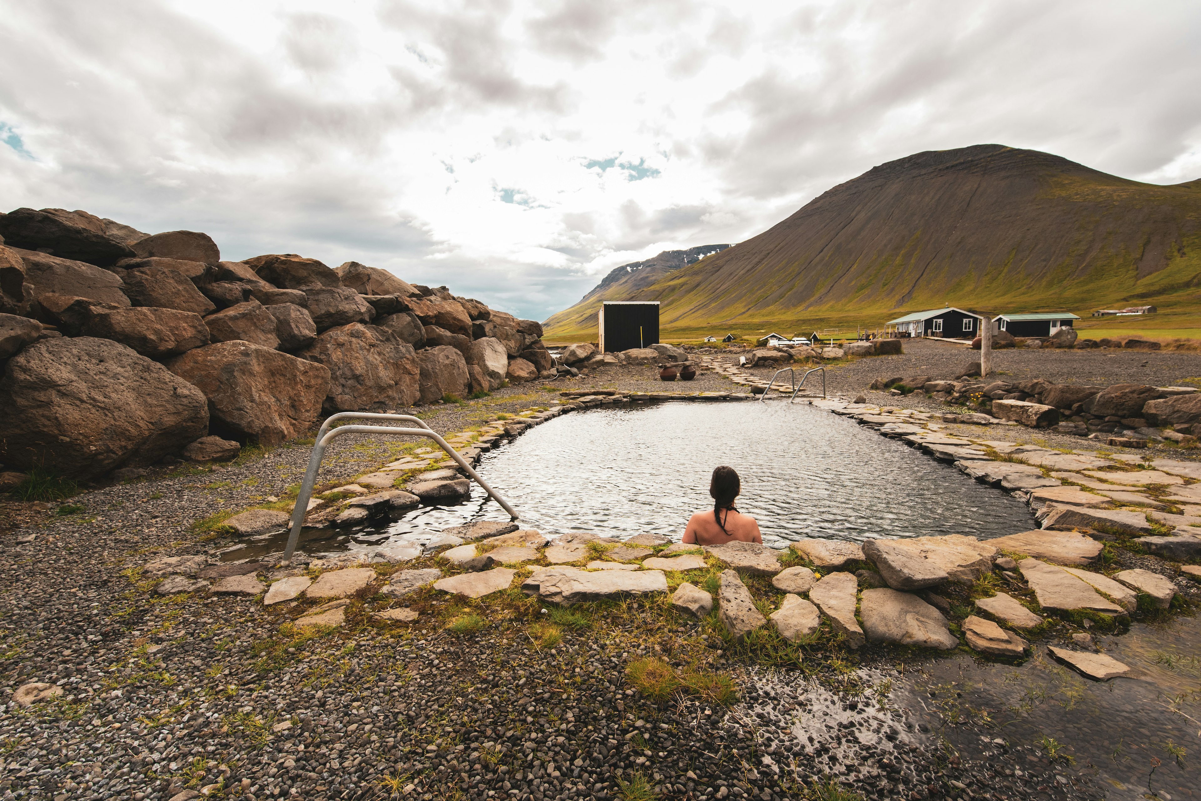 A woman bathes in Grettislaug hot spring in North Iceland.