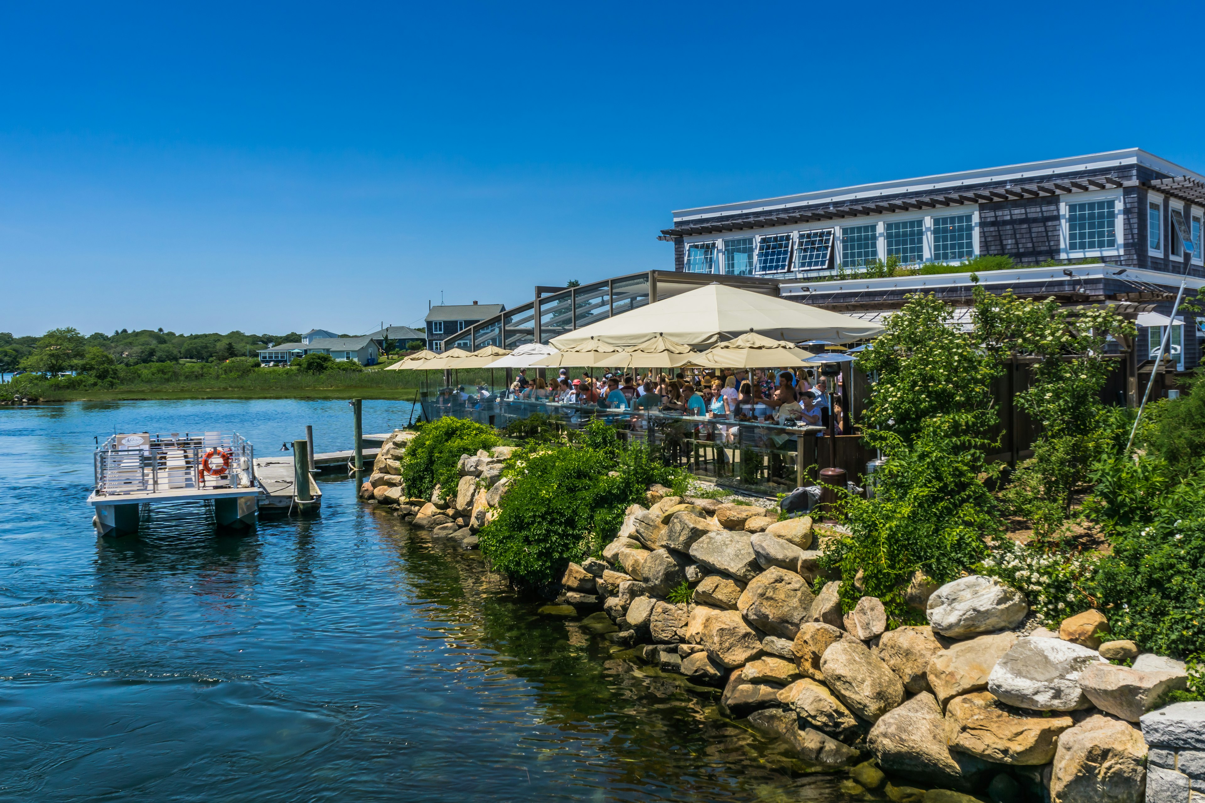 South Kingstown, Rhode Island, USA - june 23rd 2019: Matunuck Marina during summer is filled with boats and Matunuck Oyster Bar terrace is right next to it.