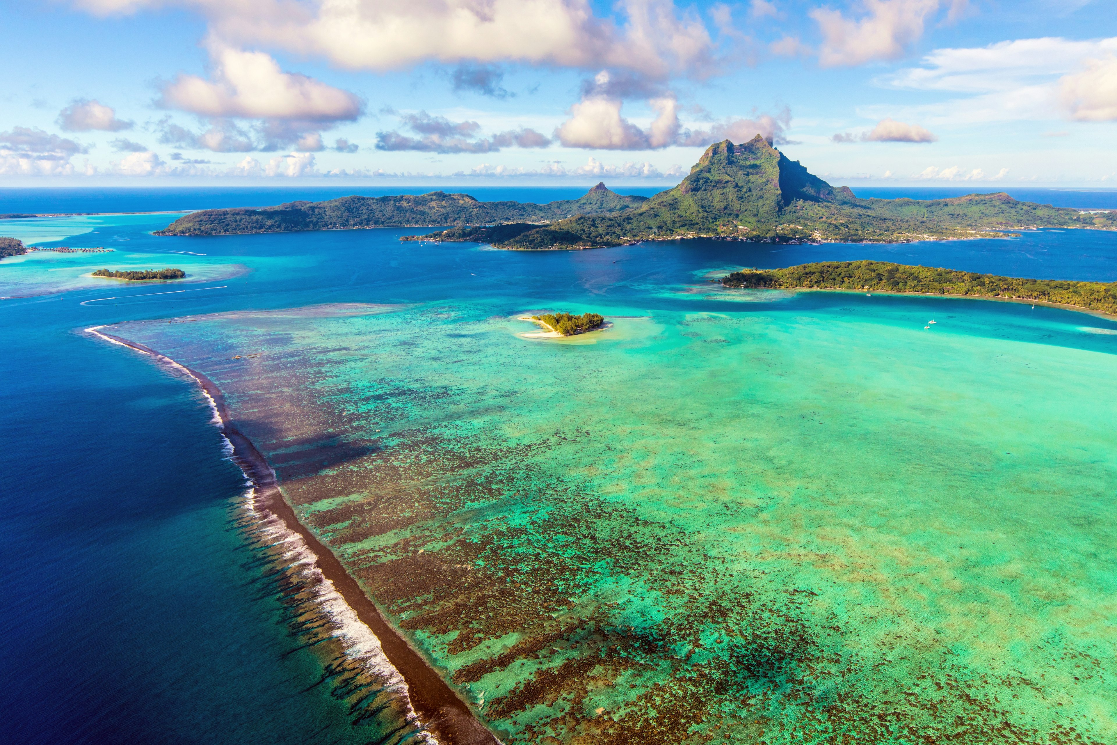 Aerial view of Bora Bora, French Polynesia, Mount Pahia, and its famous lagoon and barrier reef.