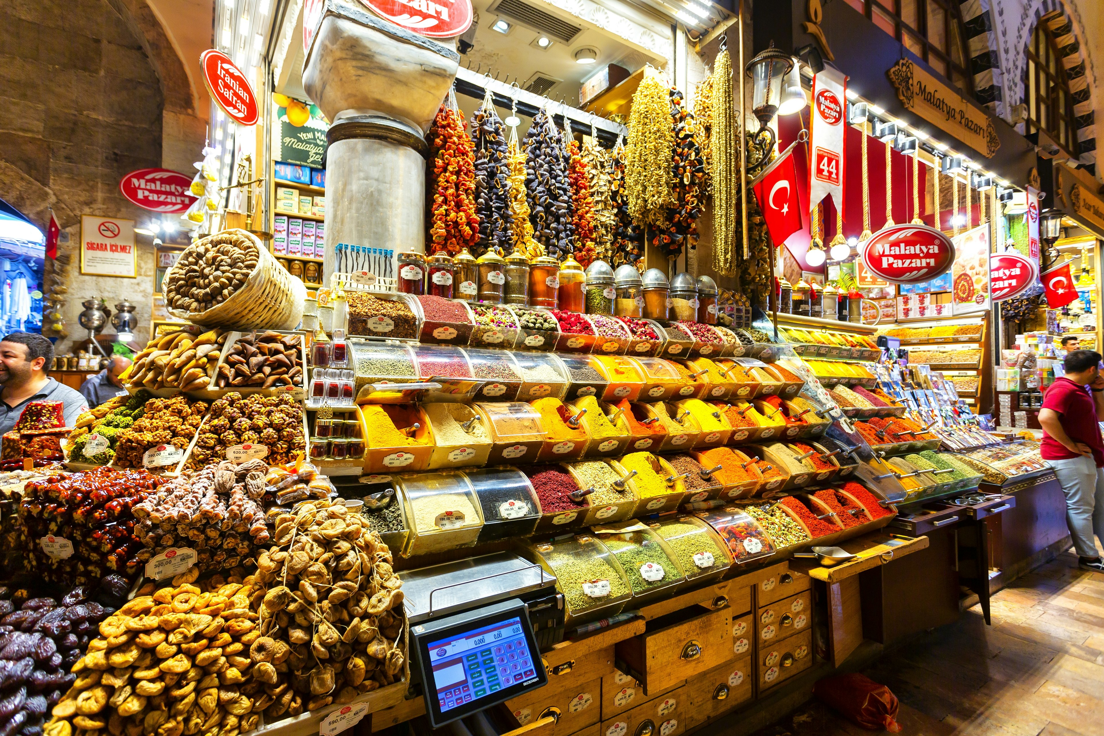 Spices and dried fruit cover a large stall in a market in Istanbul.