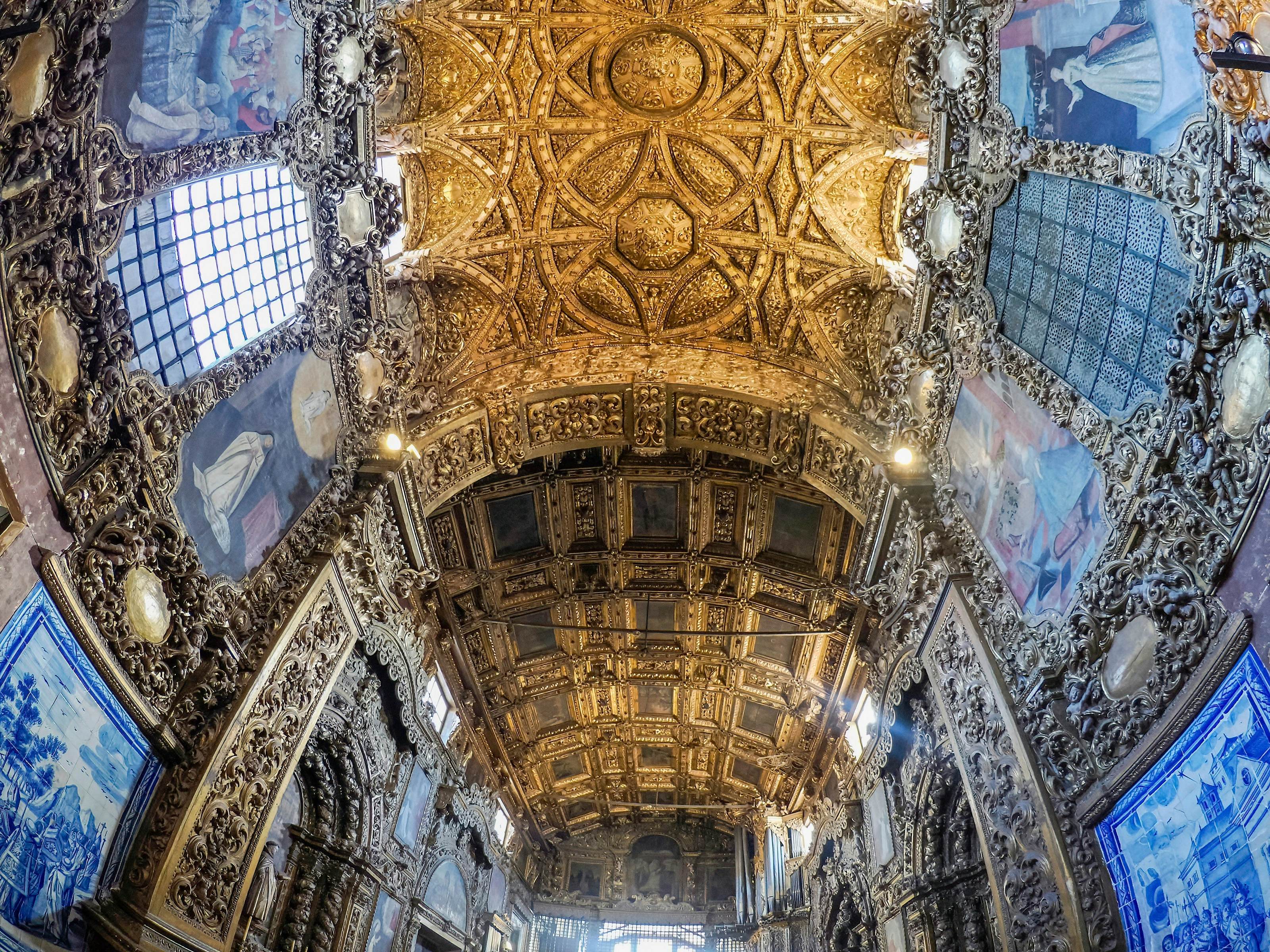 The opulent interior of a former convent building, including wood carvings and tiled walls, and an ornate gold ceiling