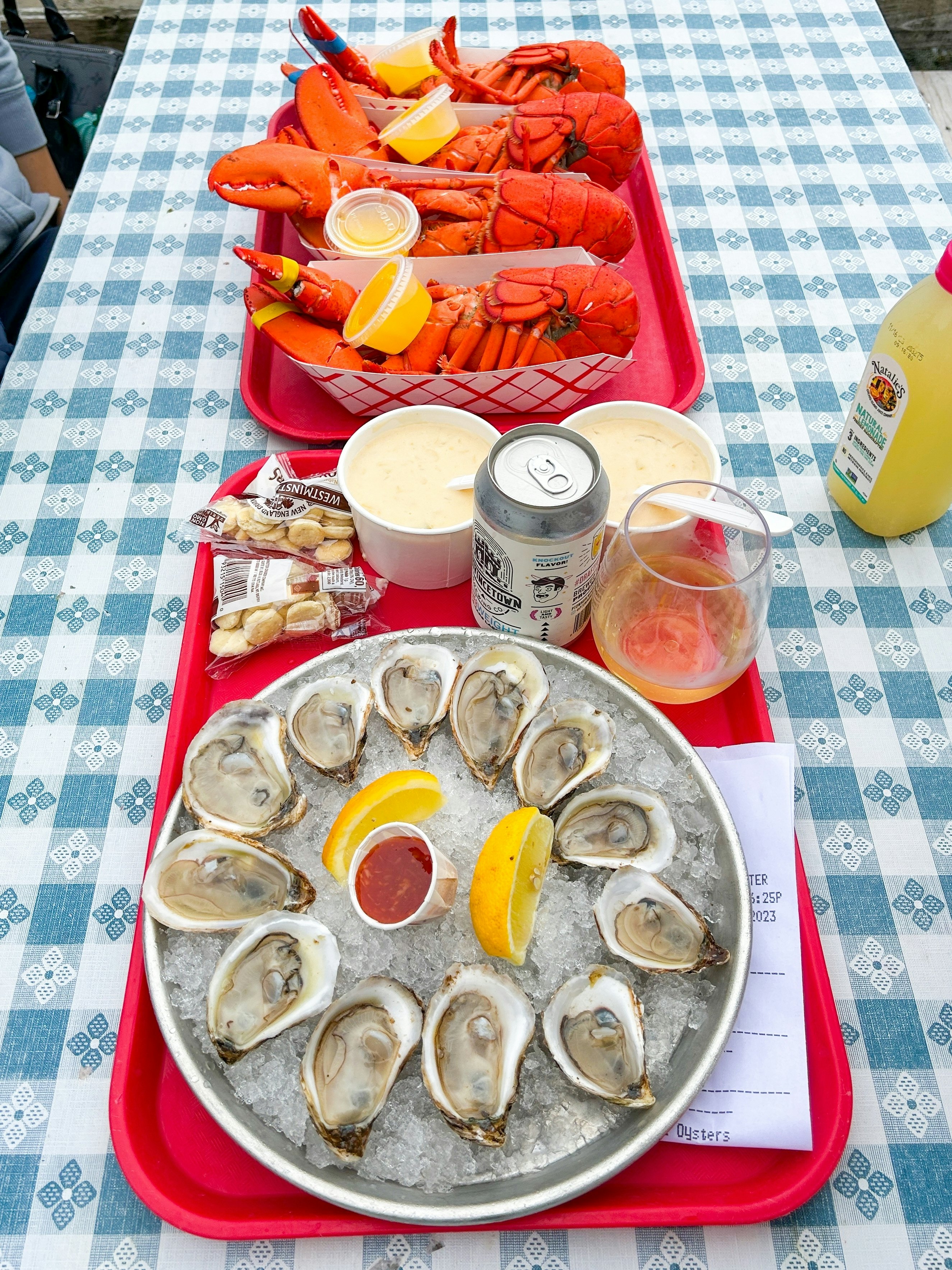 Rockport, USA – October 18, 2023: Seafood Tray with Oysters, Clam Soup, and Lobster on Table,