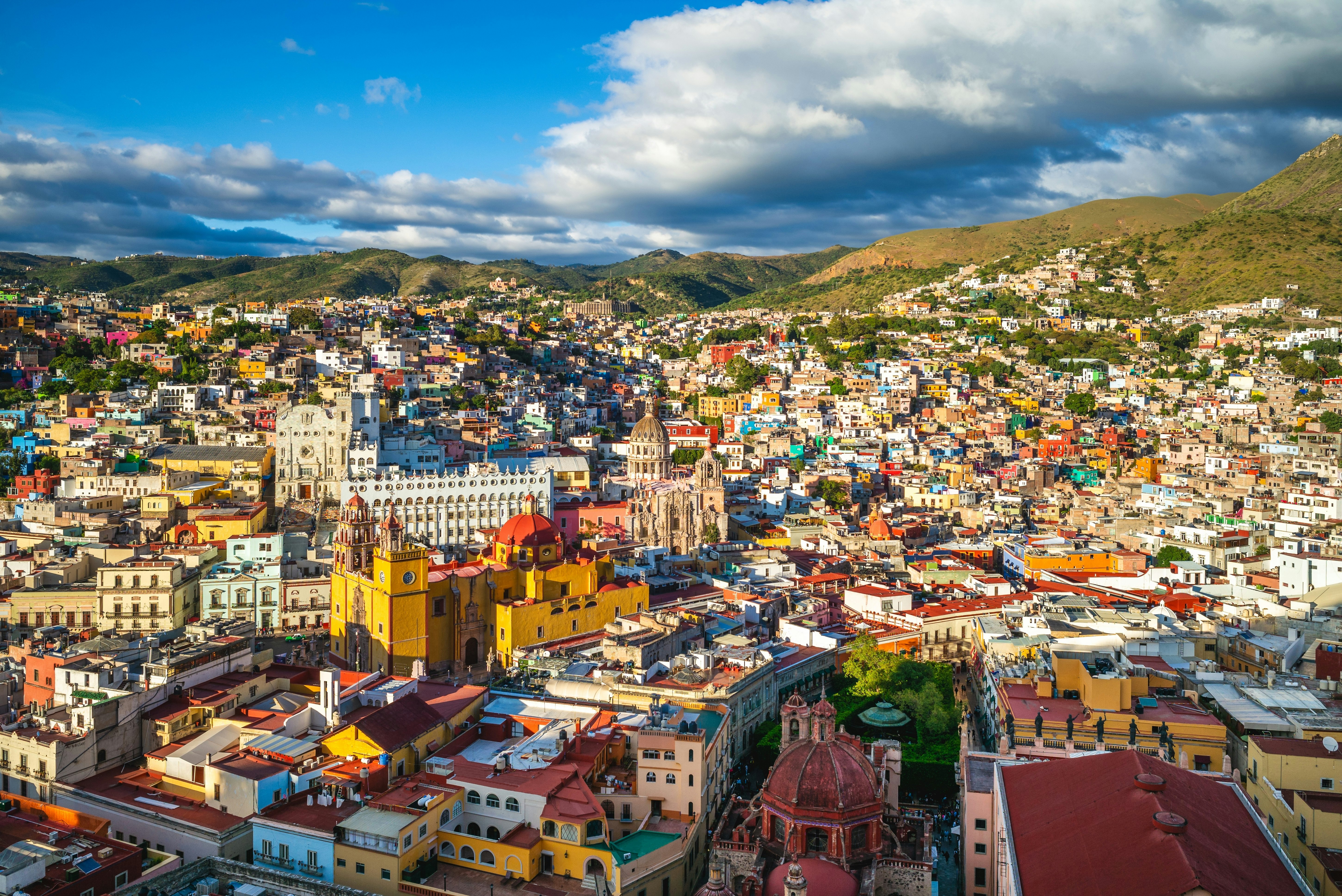 A city built into hillsides surrounding a large cathedral