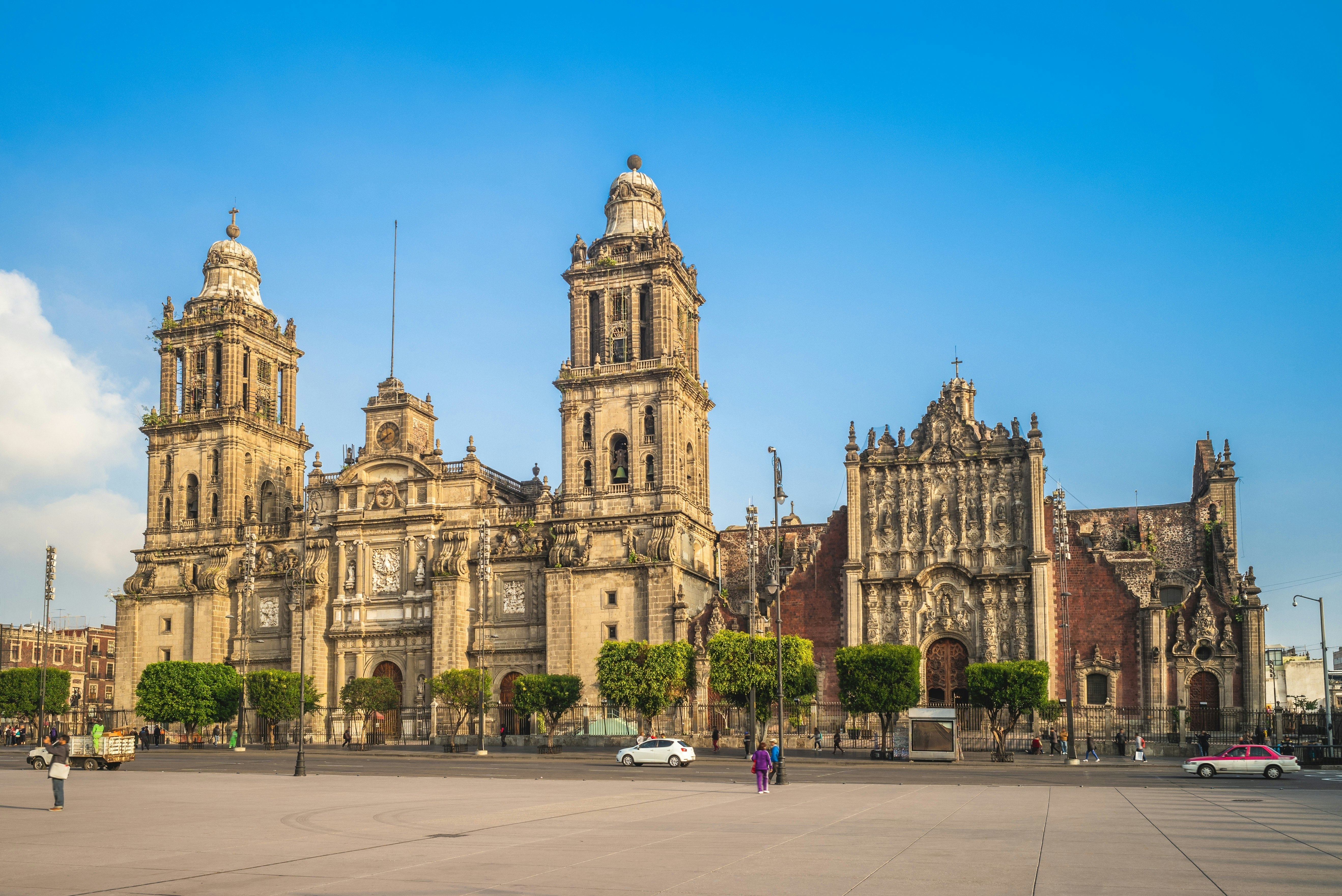 A large two-towered cathedral on the edge of a city square