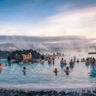 December 2017: People bathing in the hot waters of Blue Lagoon, a geothermal bath resort.
776064865
iceland, blue, lagoon, hot, water, geothermal, spring, spa, pool, bath, thermal, resort, attraction, natural, reykjavik, therapy, health, tourism, warm, lake, icelandic, people, winter, famous, tourist, lava, nature, bathing, springs, background, travel, vacation, landmark, wellness, relaxing, geology, steam, silhouette, mud, grindavík, december