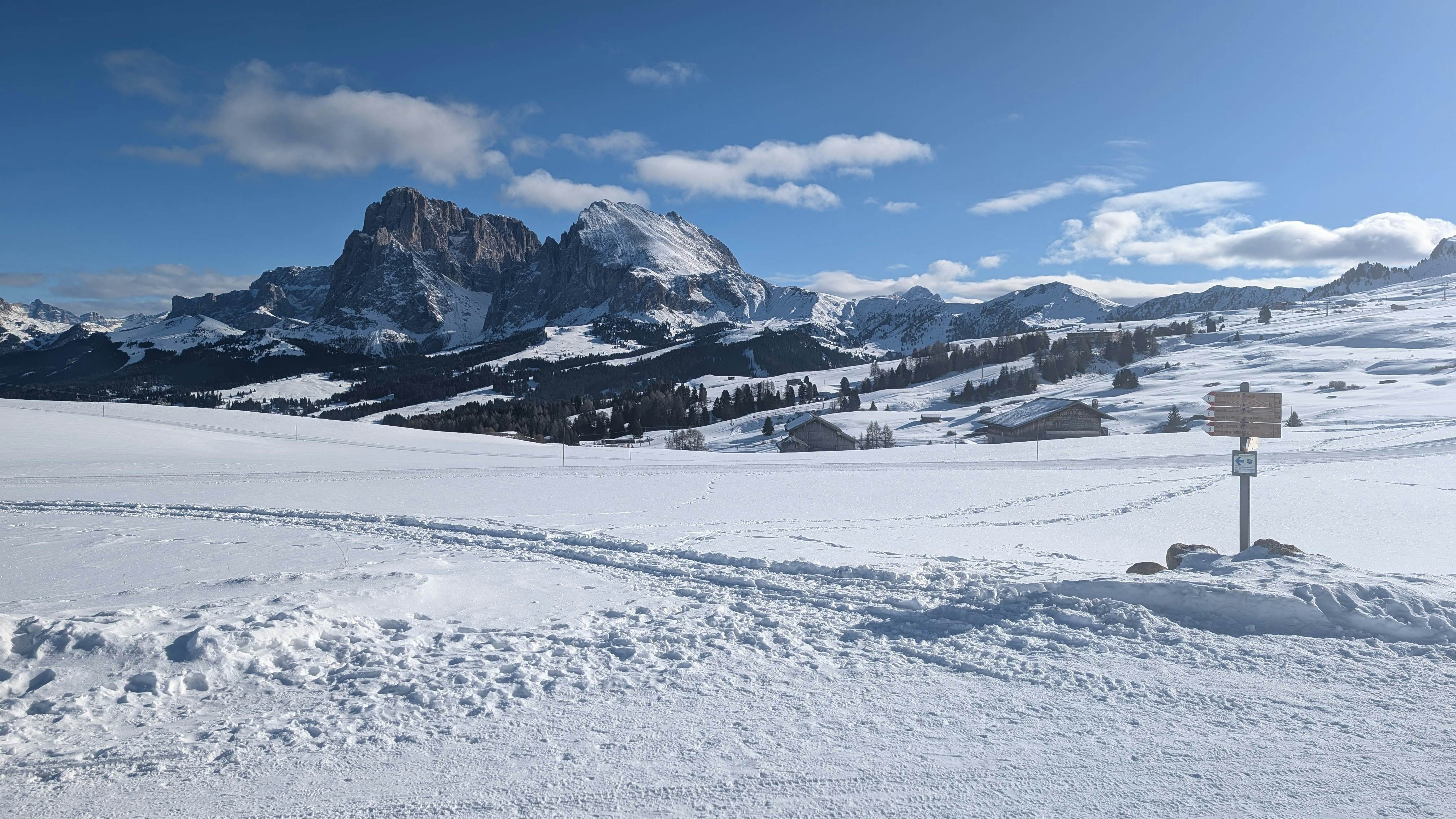 Landscape covered in snow with mountains in the background in Alpe de Siusi, Italy