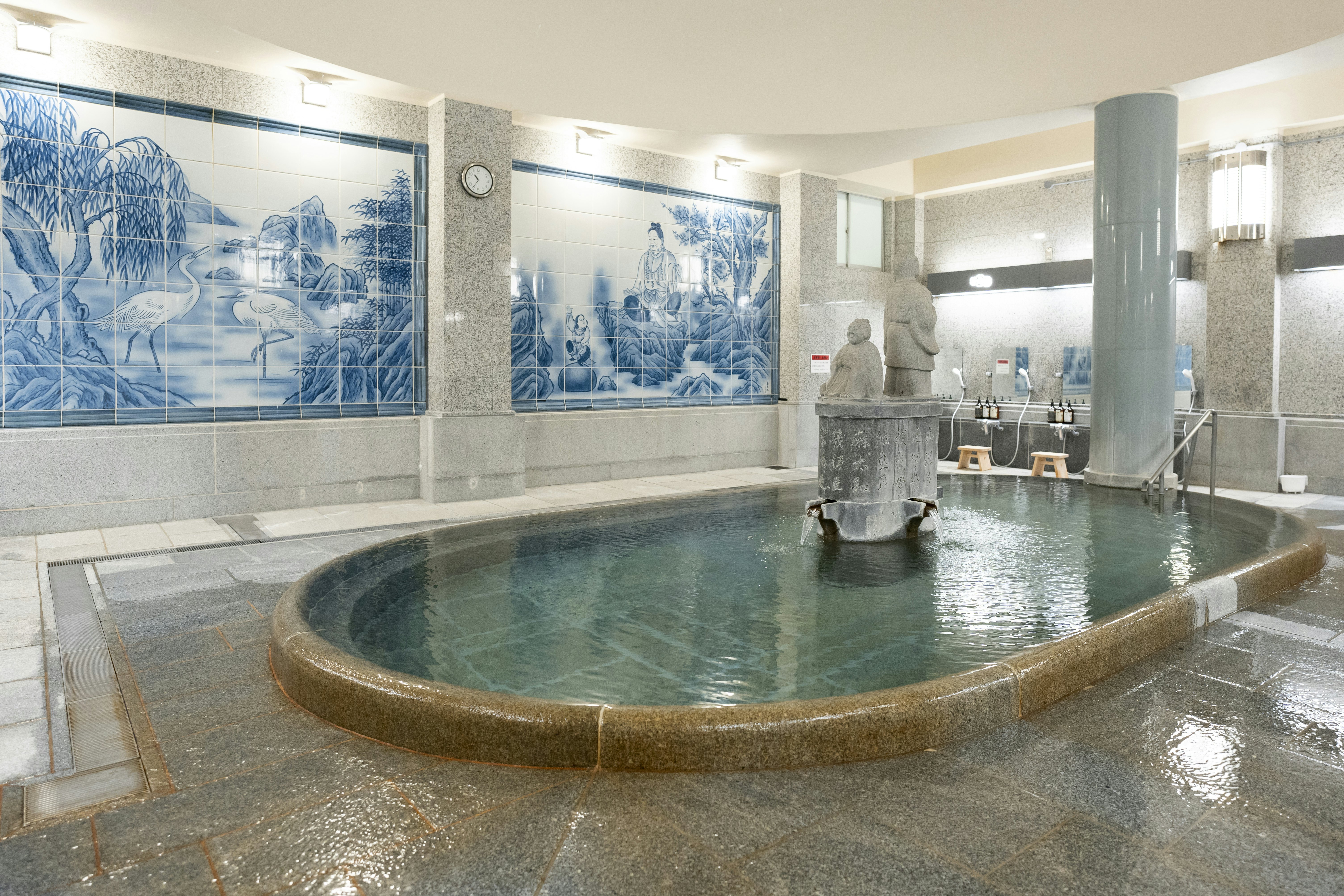 Indoor hot spring surrounded by tiled walls at Dogo Onsen.