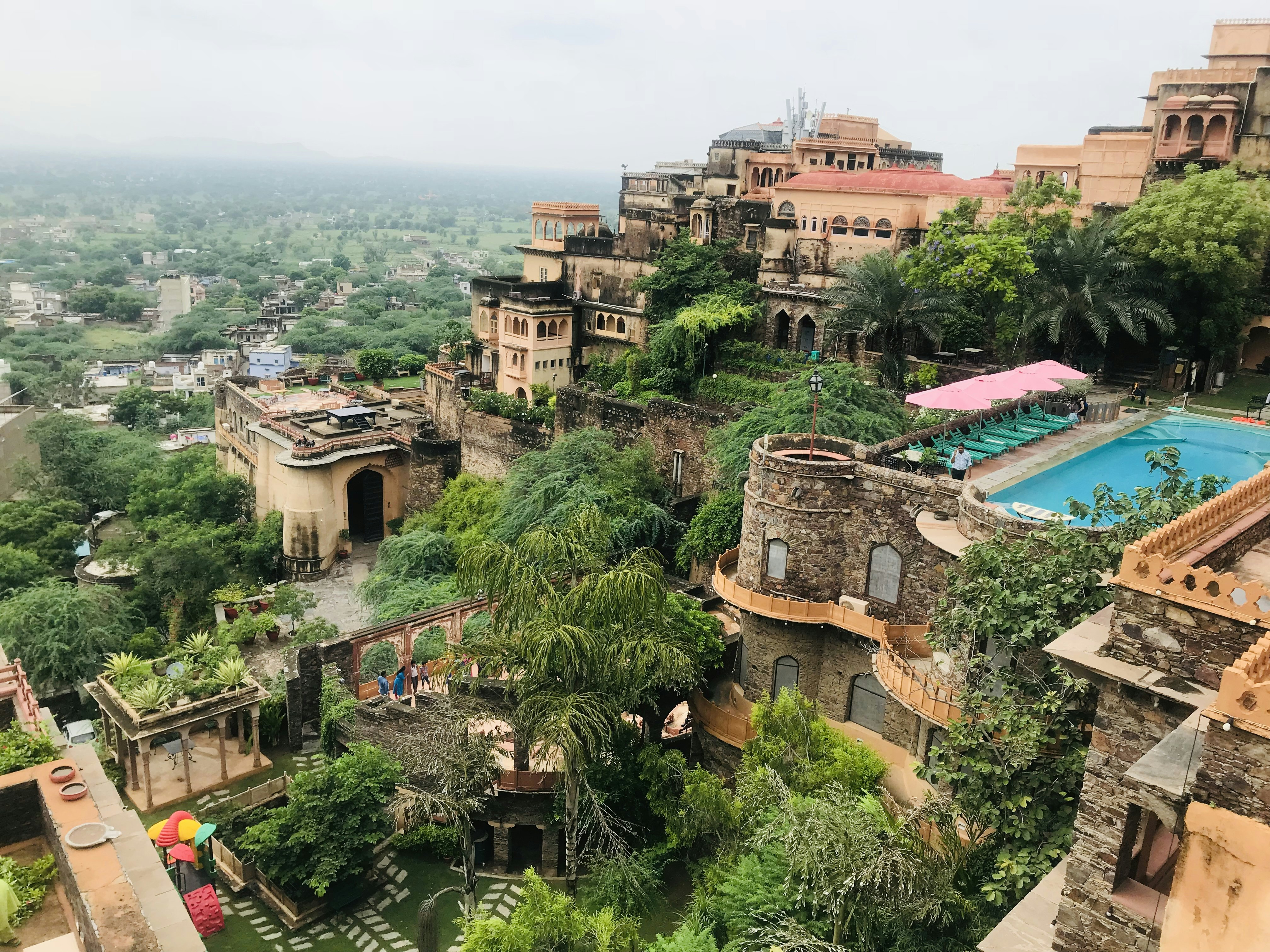 A hillside fortress with a rooftop swimming pool