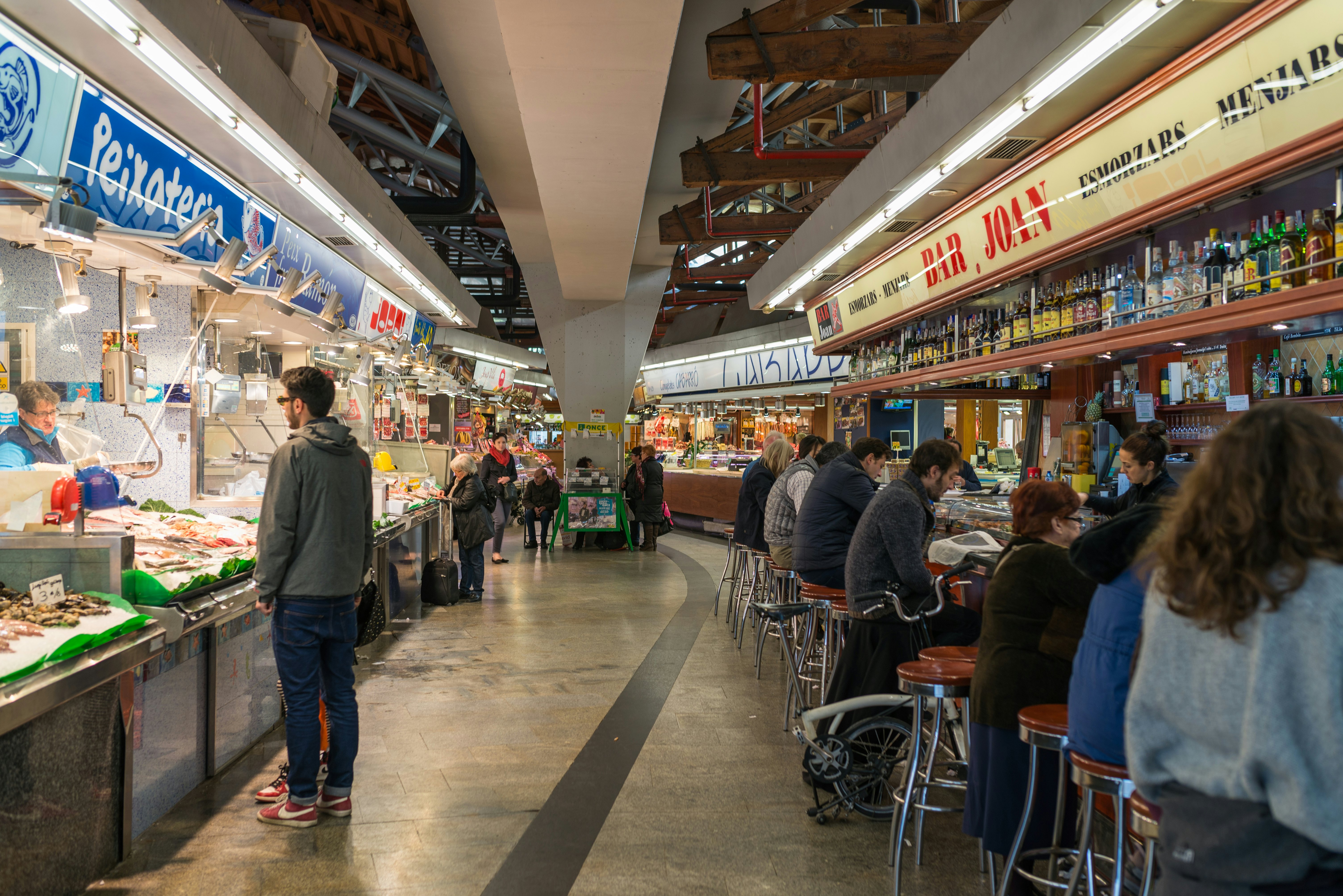 Customers line up at the seafood and tapas bars in Santa Caterina market.