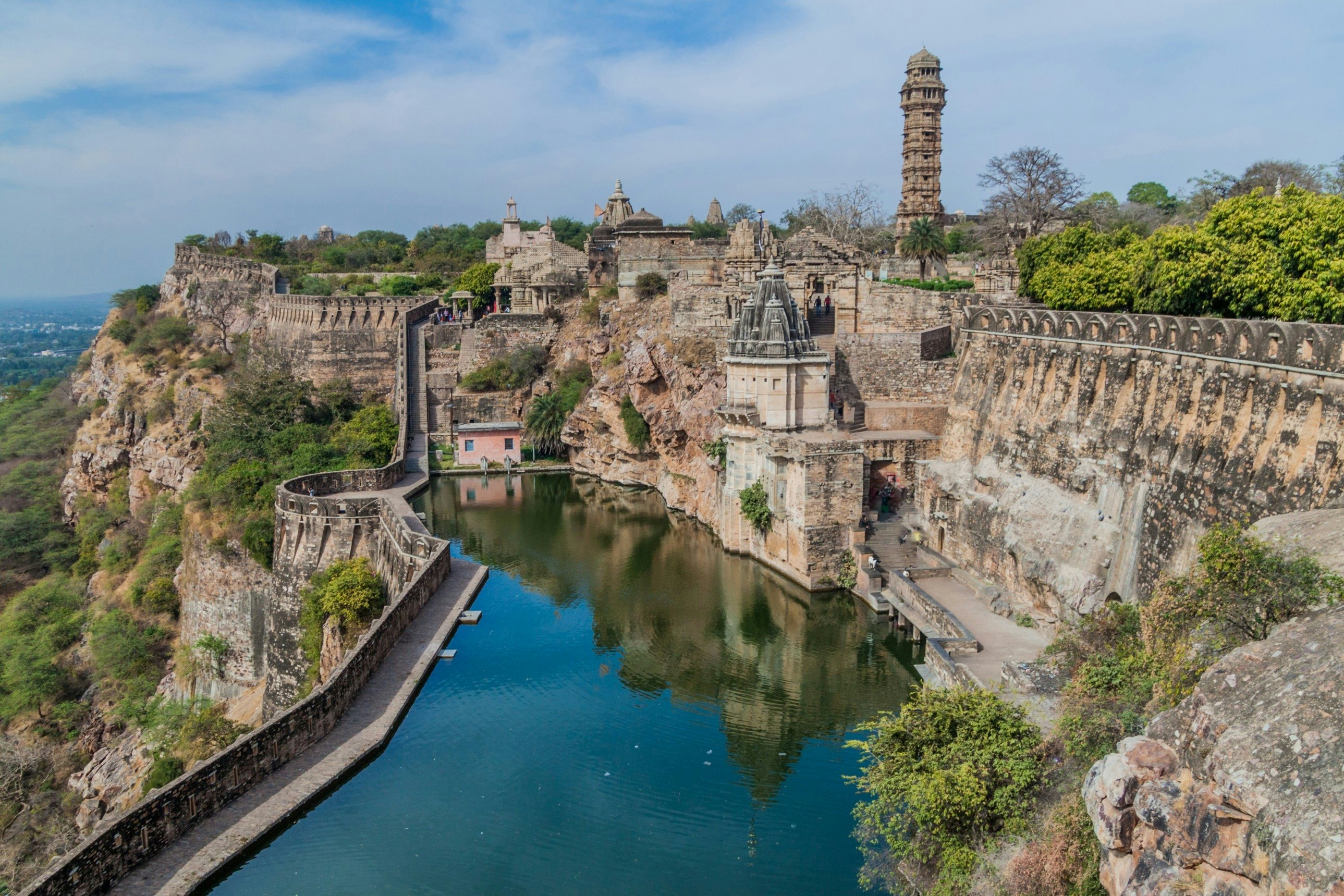 A reservoir within the walls of a fortress with a tall ornate tower