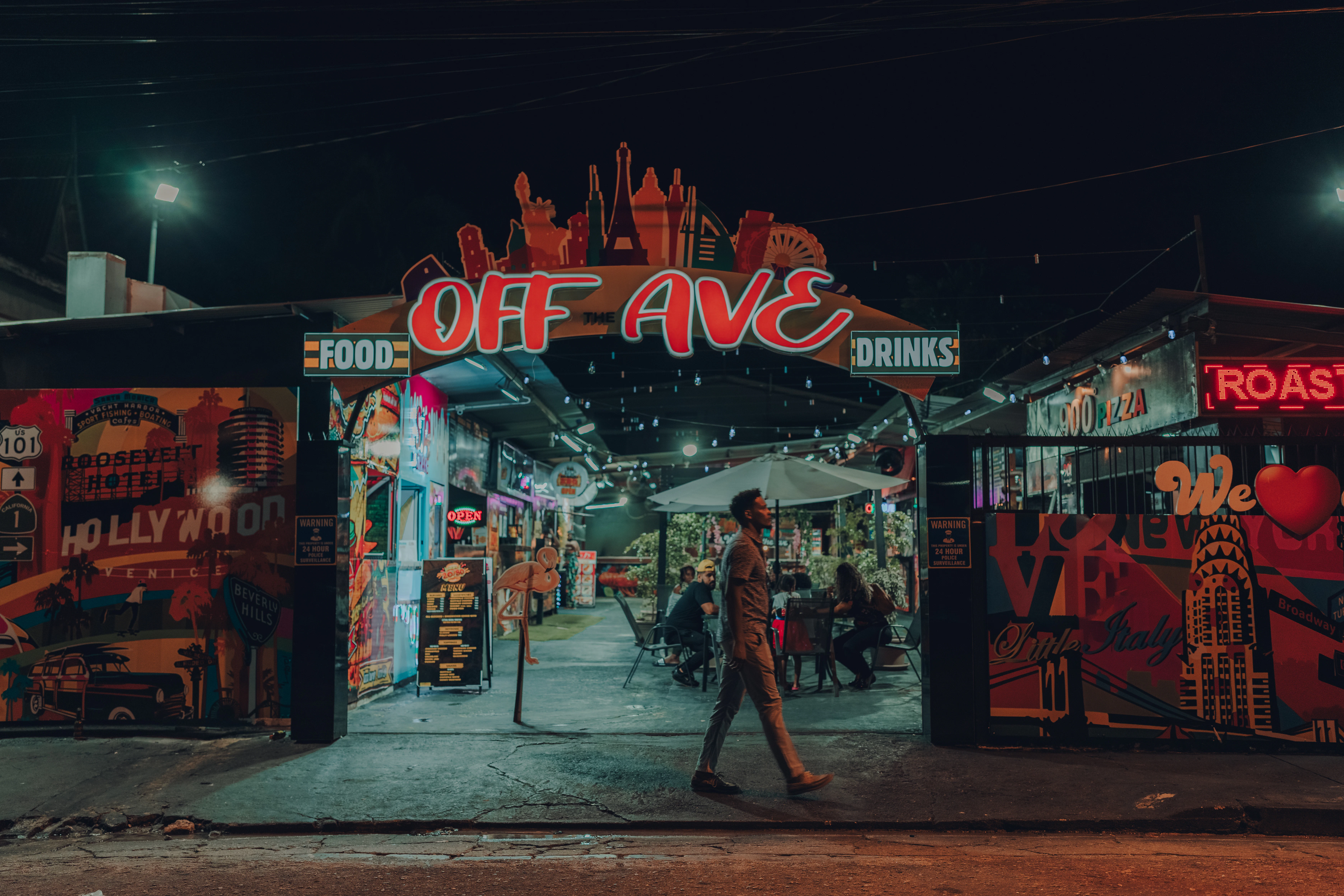 A man walks in front of a food alley at 39 Carlos St, Ariapita Avenue, Port of Spain, Trinidad.