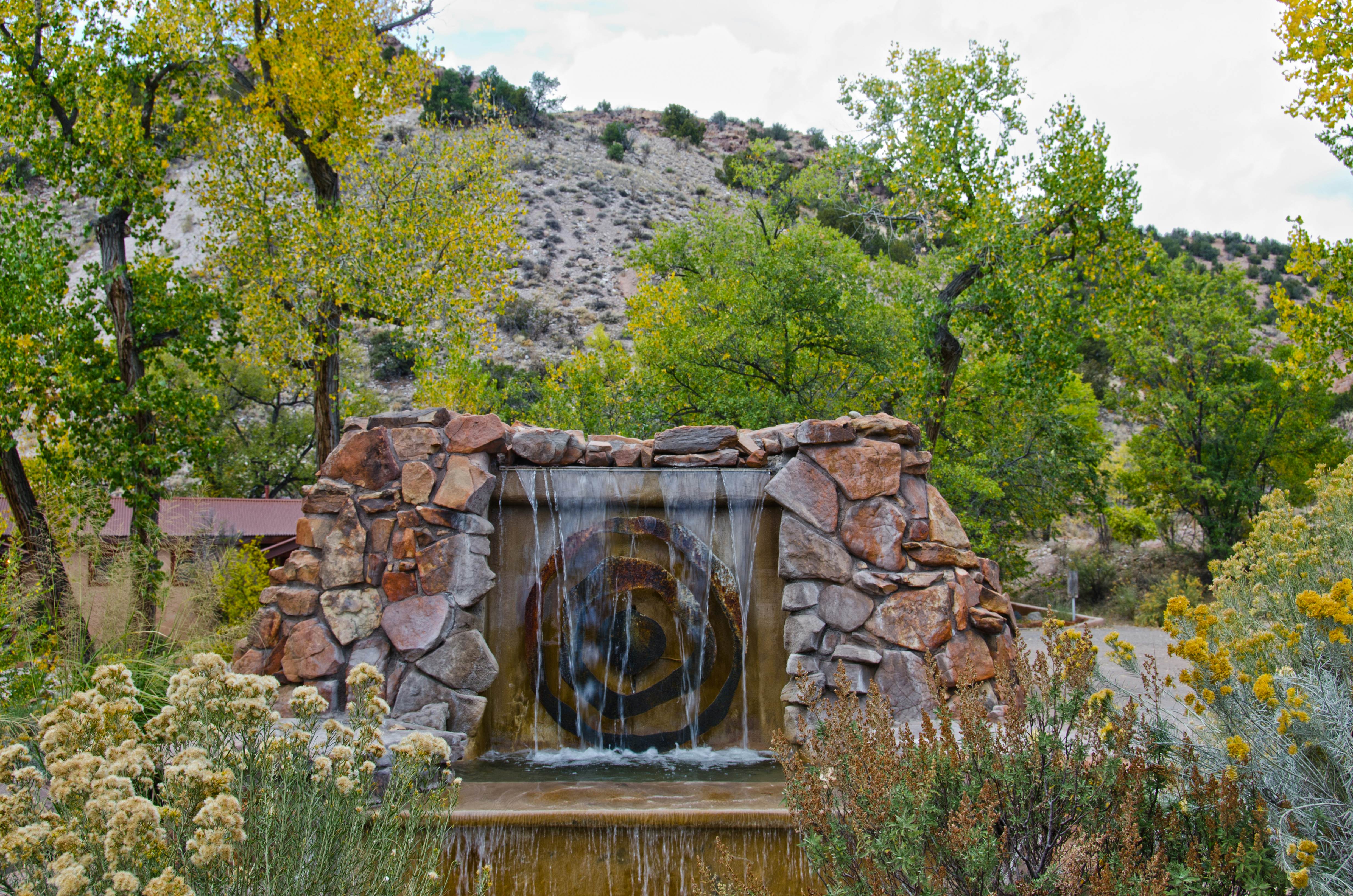 A decorative fountain in a rural area trickles water