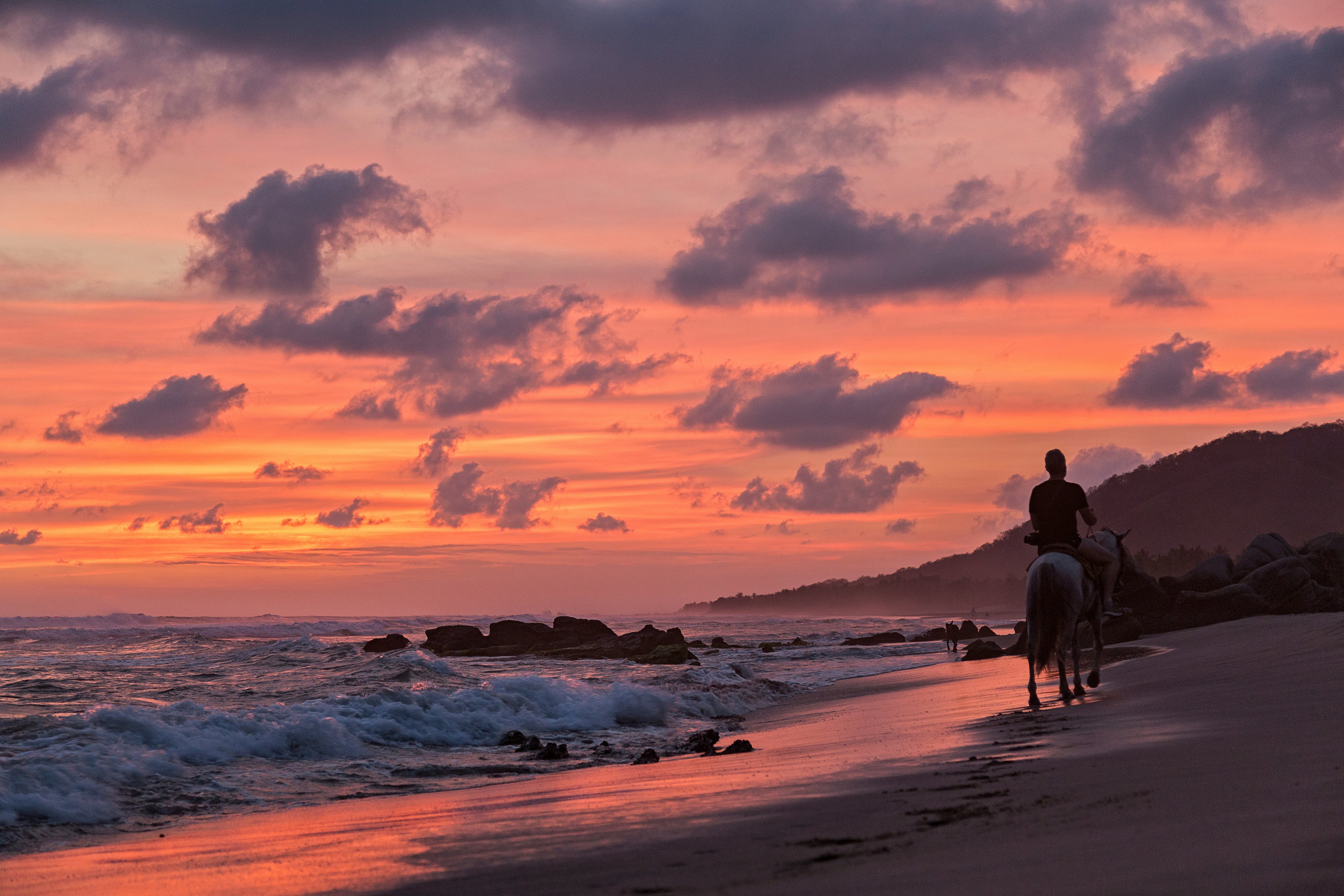 Man riding at sunset on the beach Troncones Guerrero Mexico  License Type: media  Download Time: 2023-05-19T08:17:31.000Z  User:   Is Editorial: No  purchase_order: