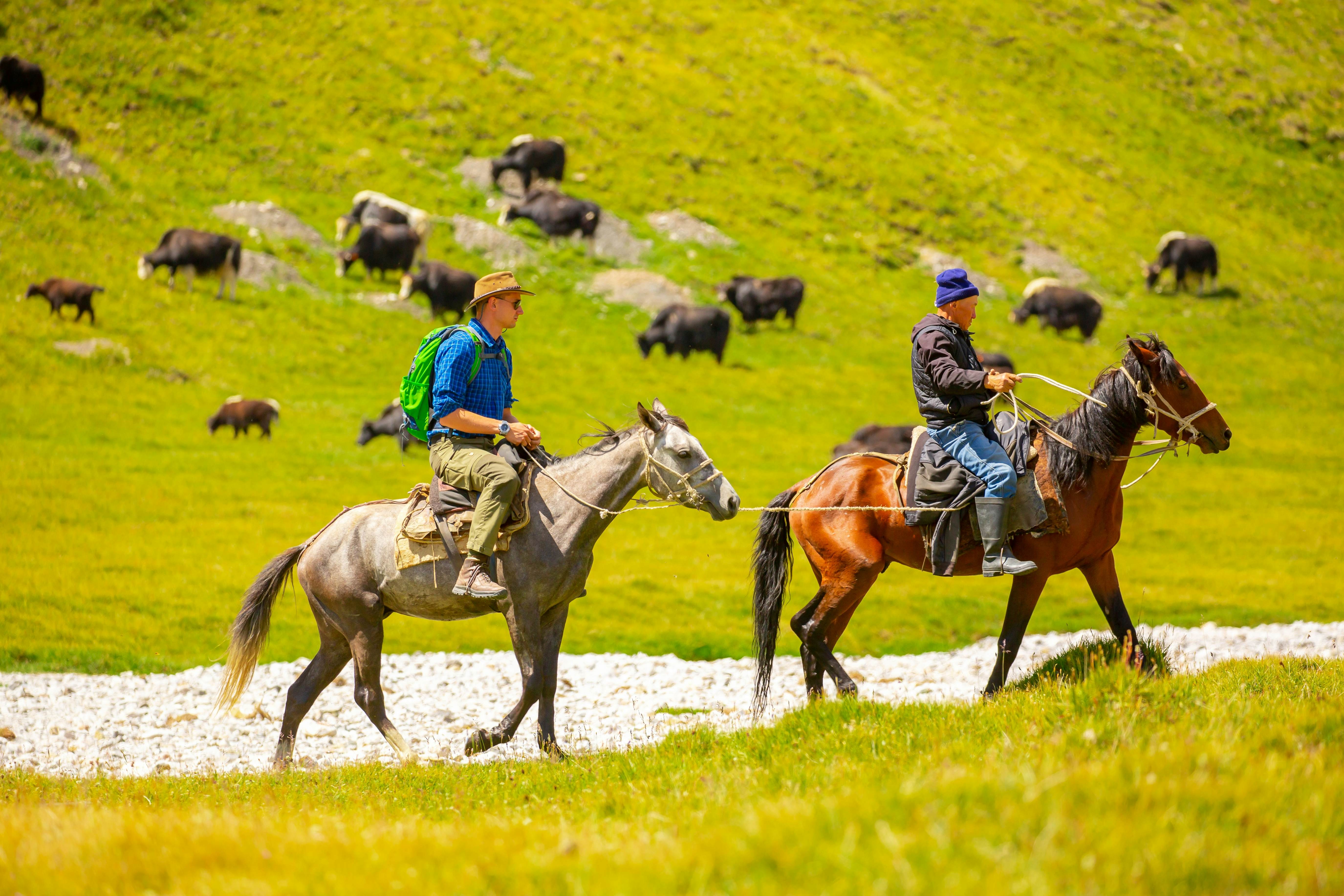 Two riders on horseback in Kyrgyzstan