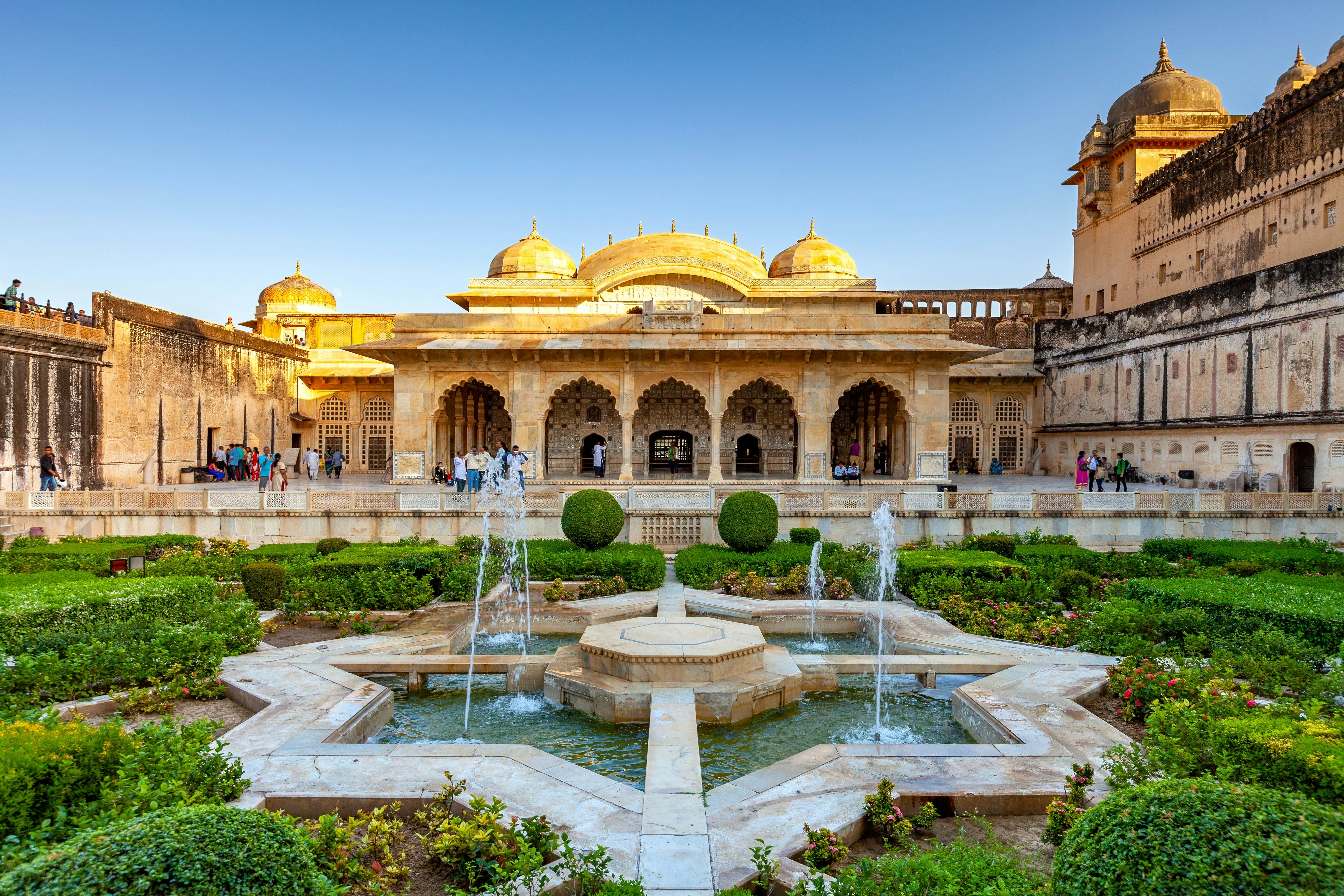 A star-shaped fountain in an ornate courtyard within a fort with yellow stone walls