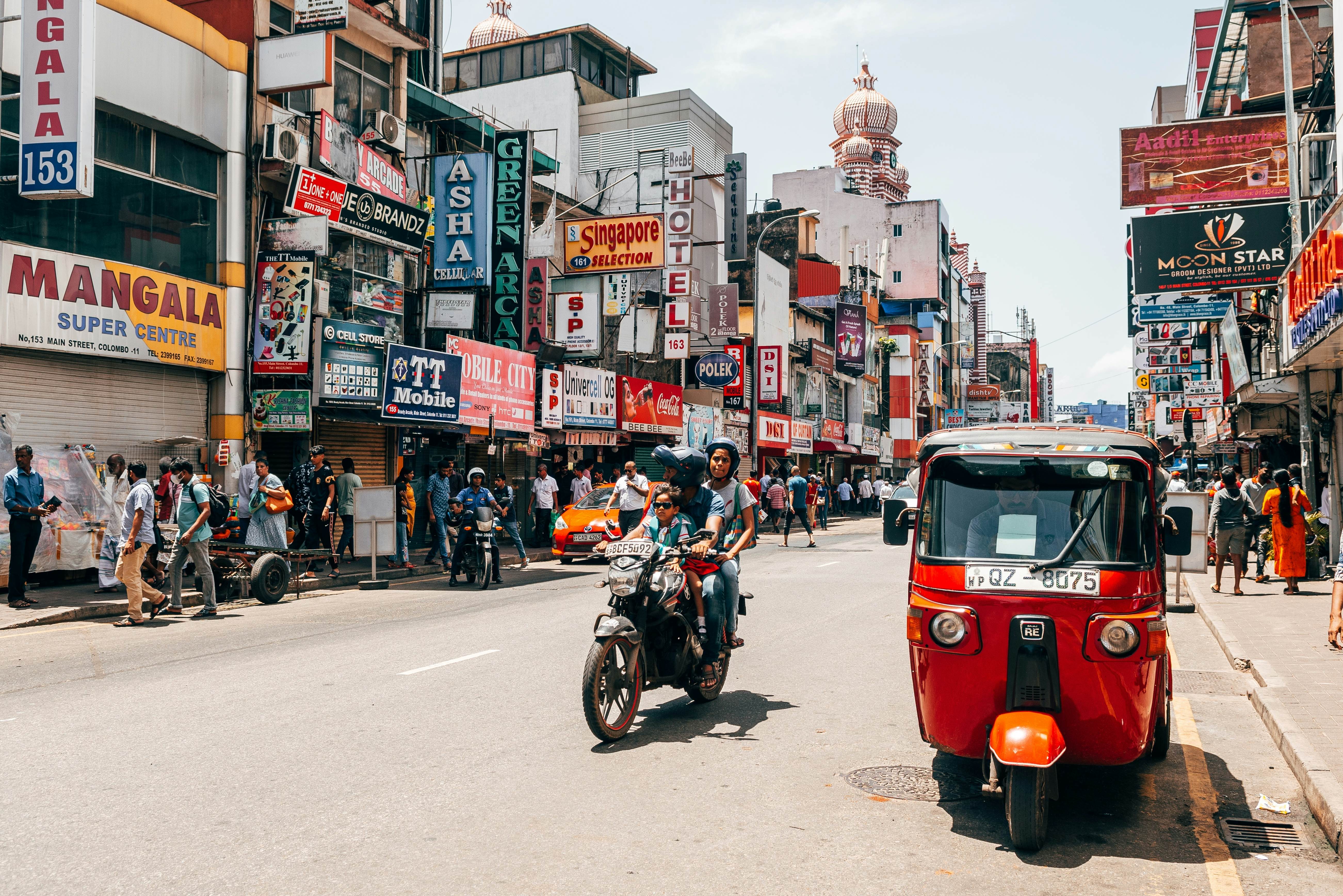 Street view of a rickshaw and motorcycle in Colombo, Sri Lanka