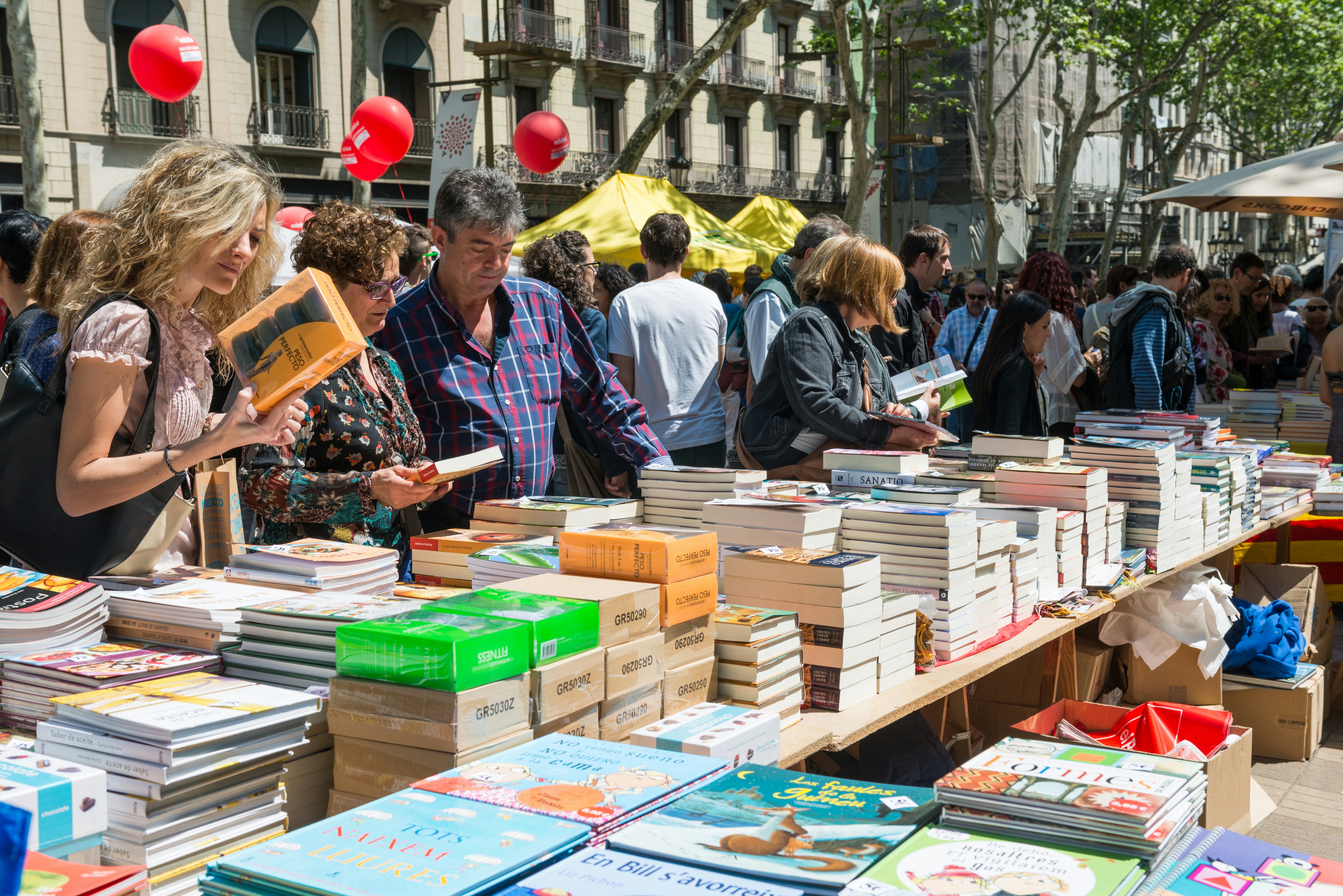 People browse books at a book stall during Dia de Saint Jordi in Barcelona.