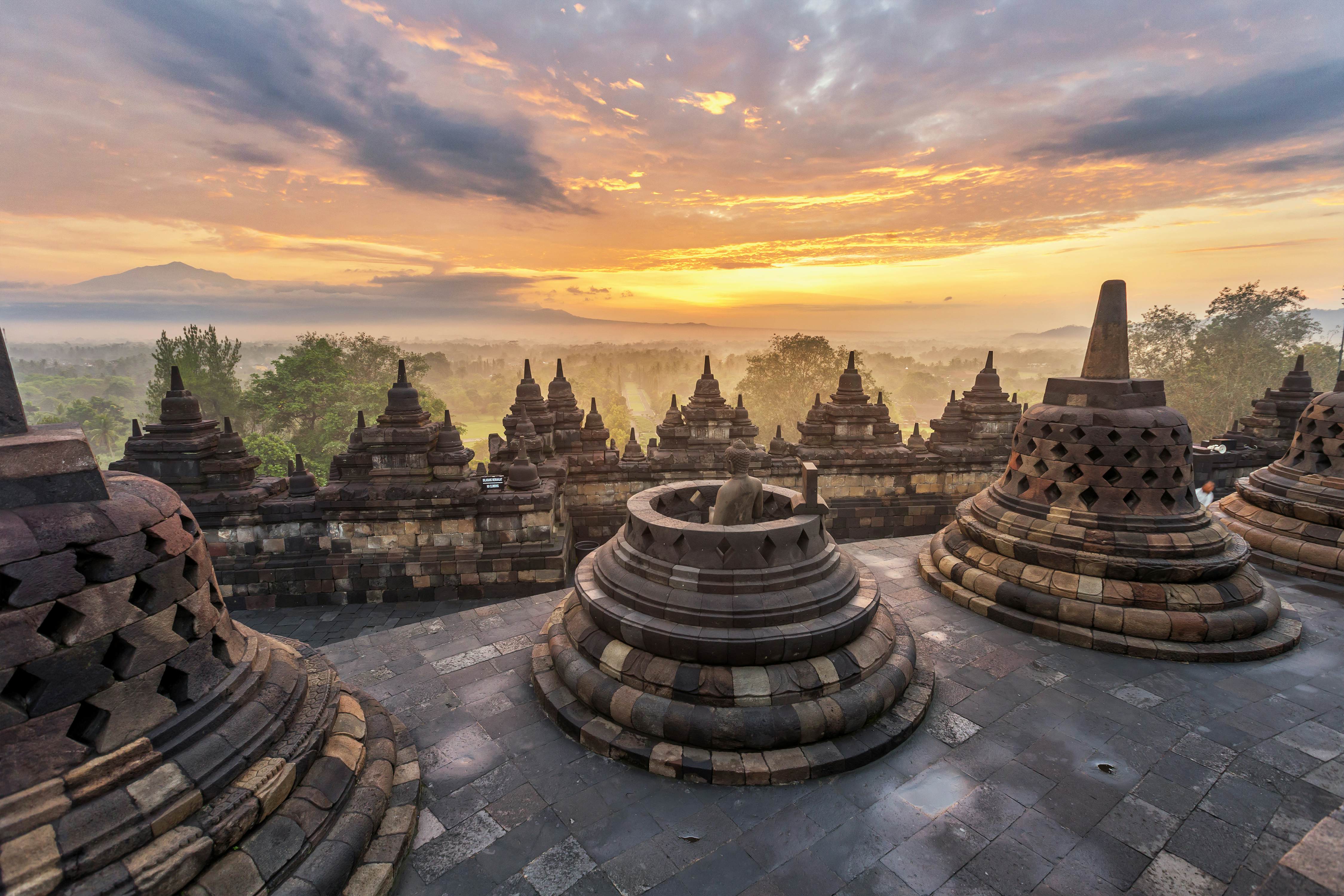 A dramatic and colourful sunrise seen from Borobudur temple, Java.