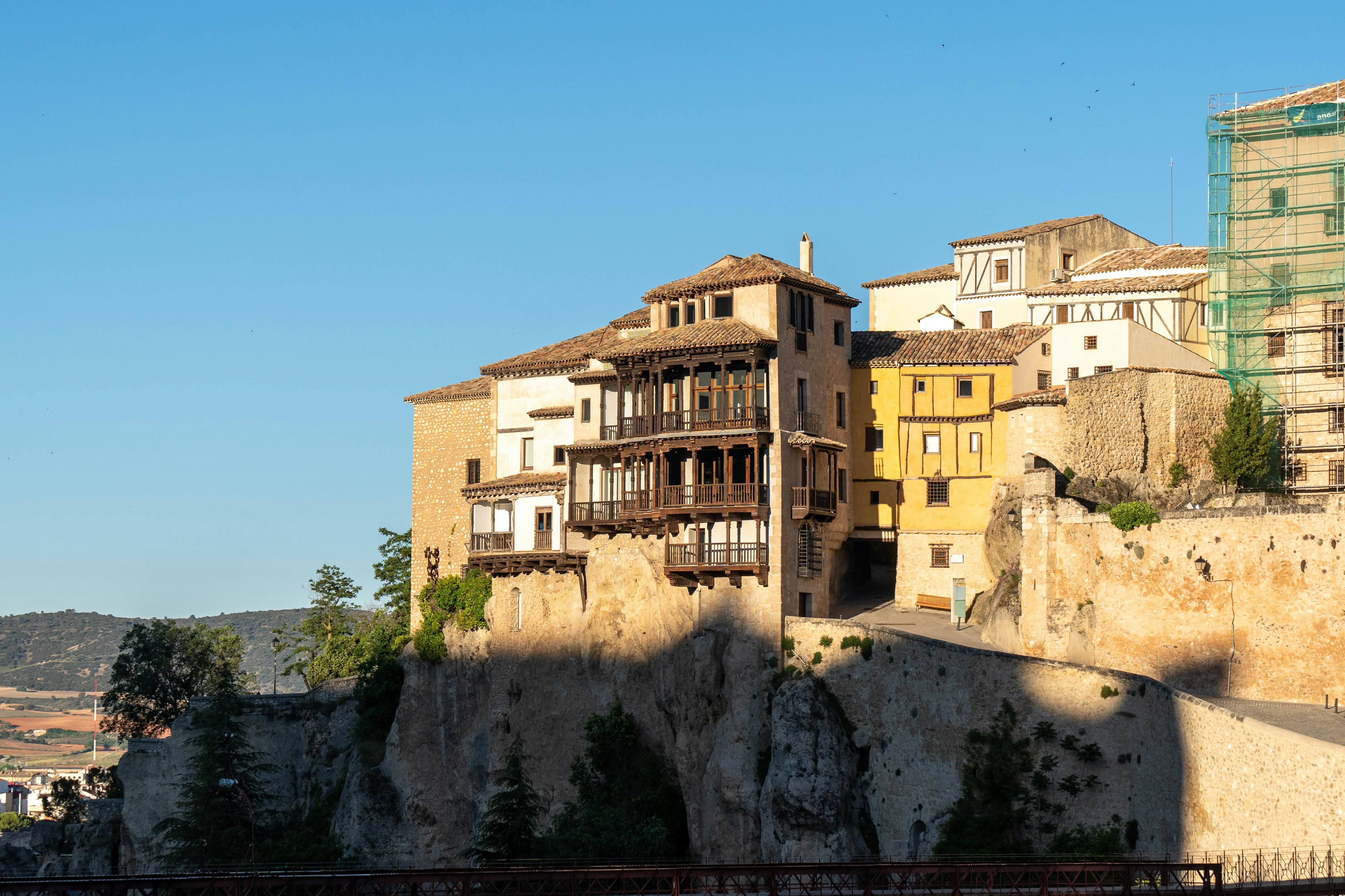 Buildings with balconies sit right on a cliff's efge in Cuenca.