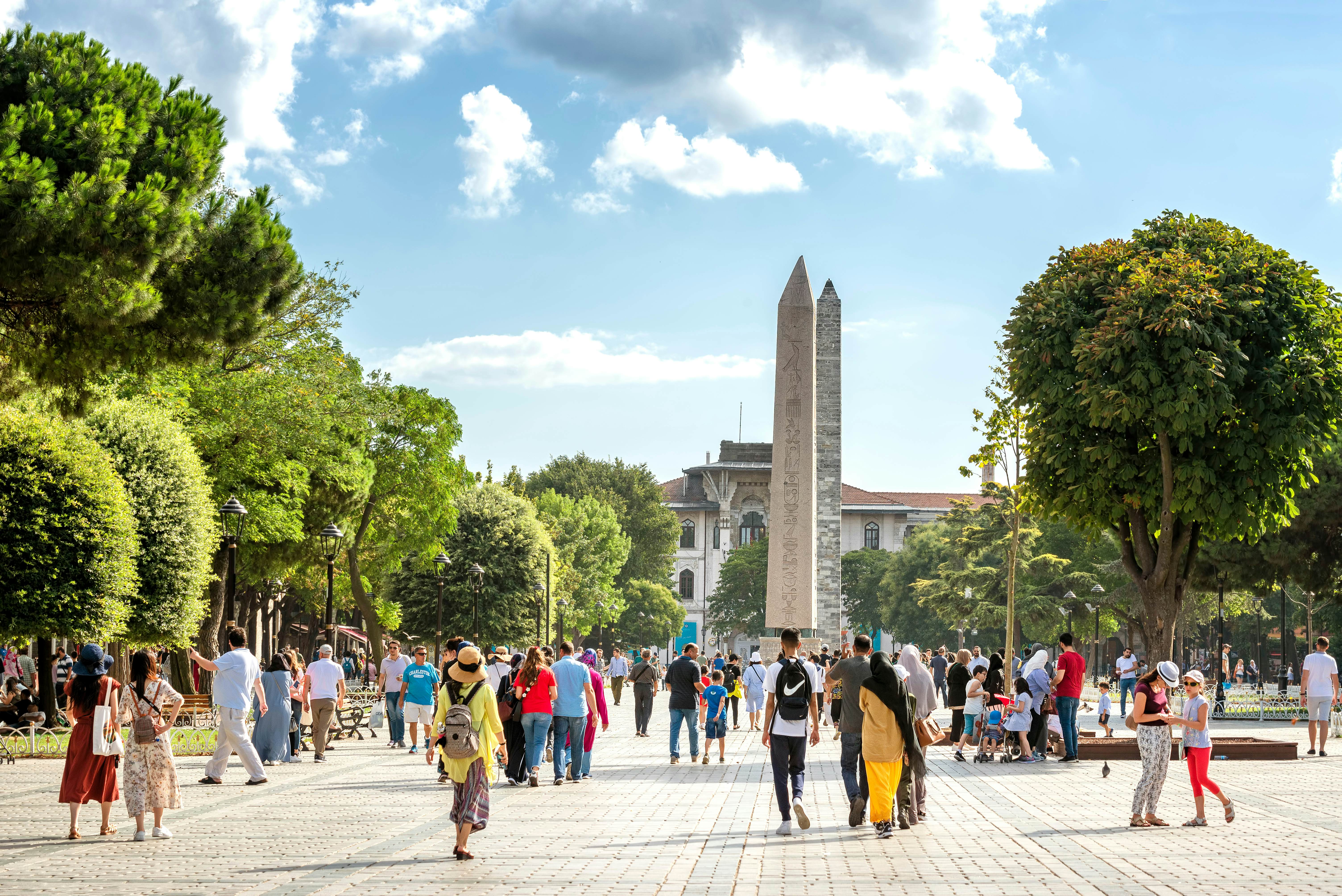 People walking at Sultan Ahmet Square (The Old Hippodrome Of Constantinople), famous tourist attraction and landmark of Istanbul's historic peninsula.