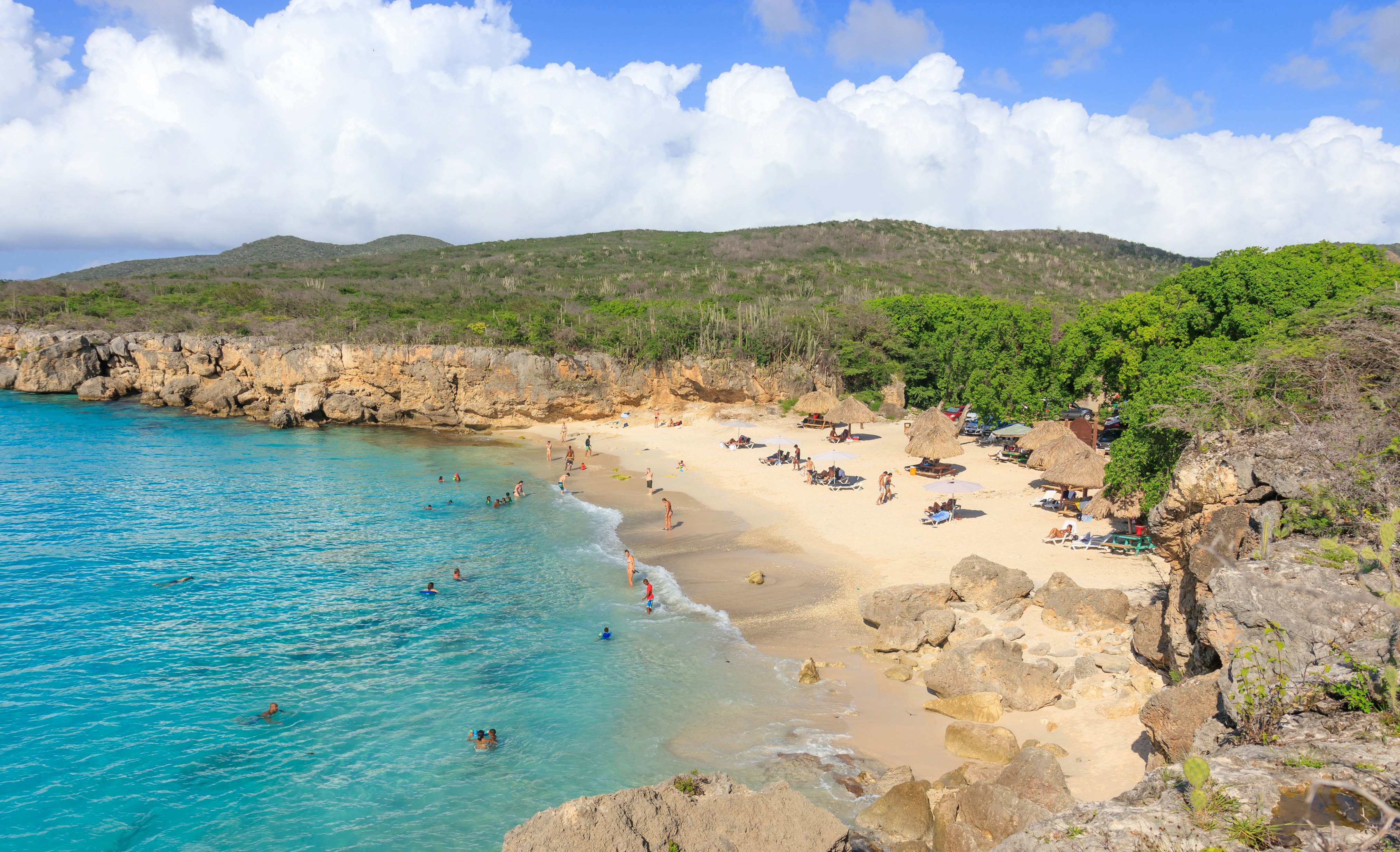 A small sandy cove surrounded by cliffs