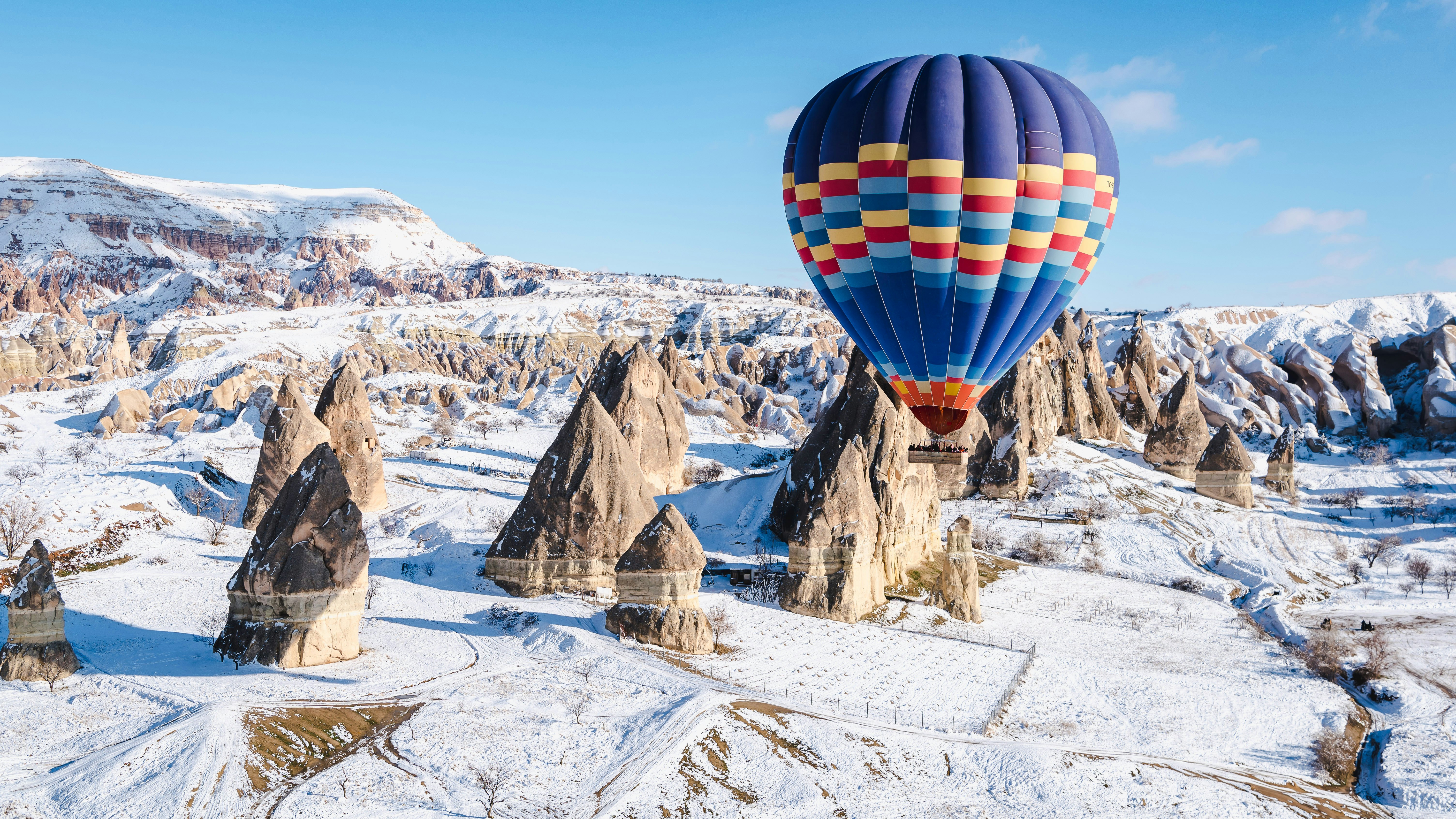 Colorful hot air balloons flying over a mountain