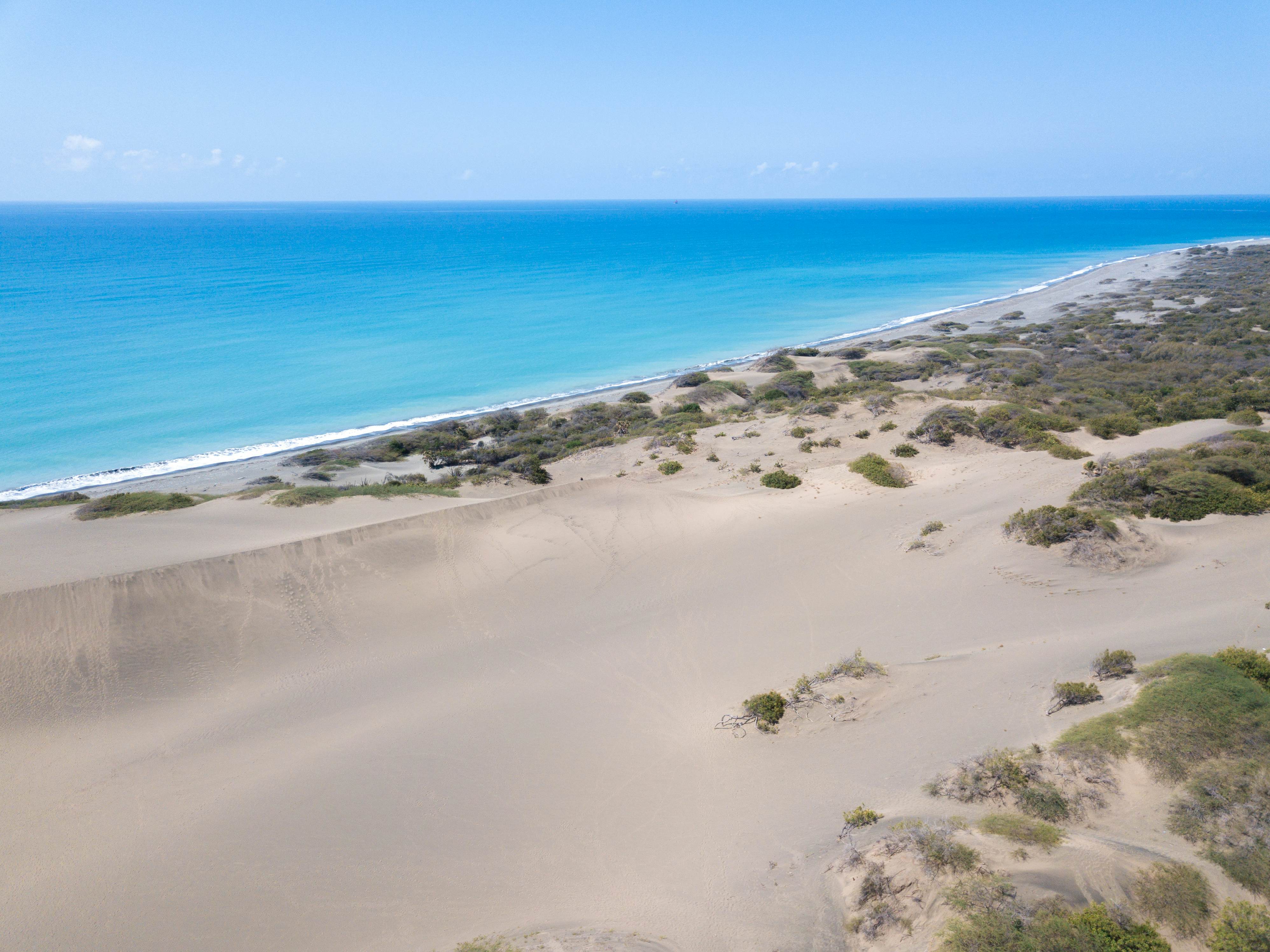 Rolling sand dunes down toward the sea at Dunes de Bani in Dominican Republic