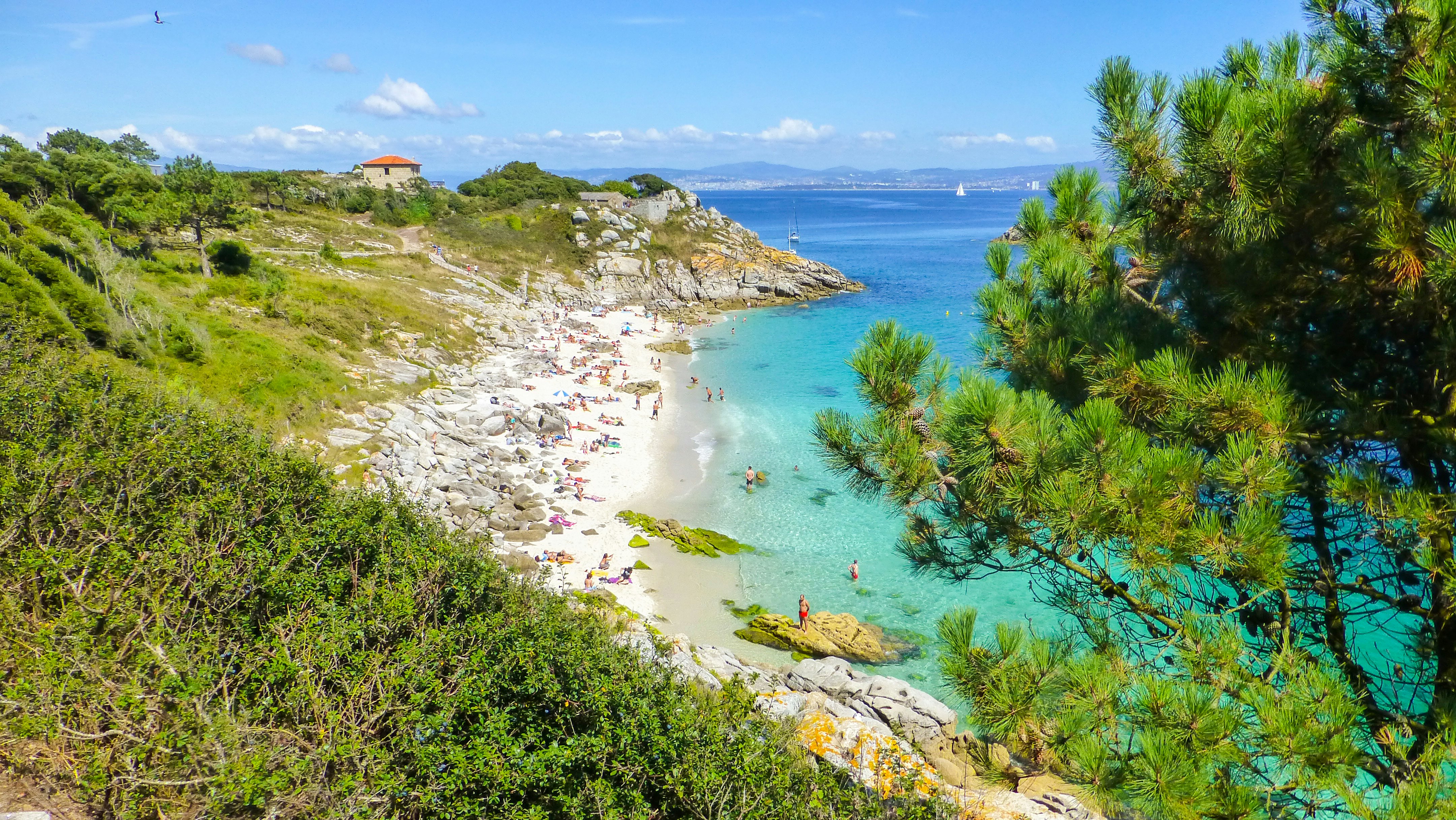 Aerial shot of people on the beach at Cies Islands.