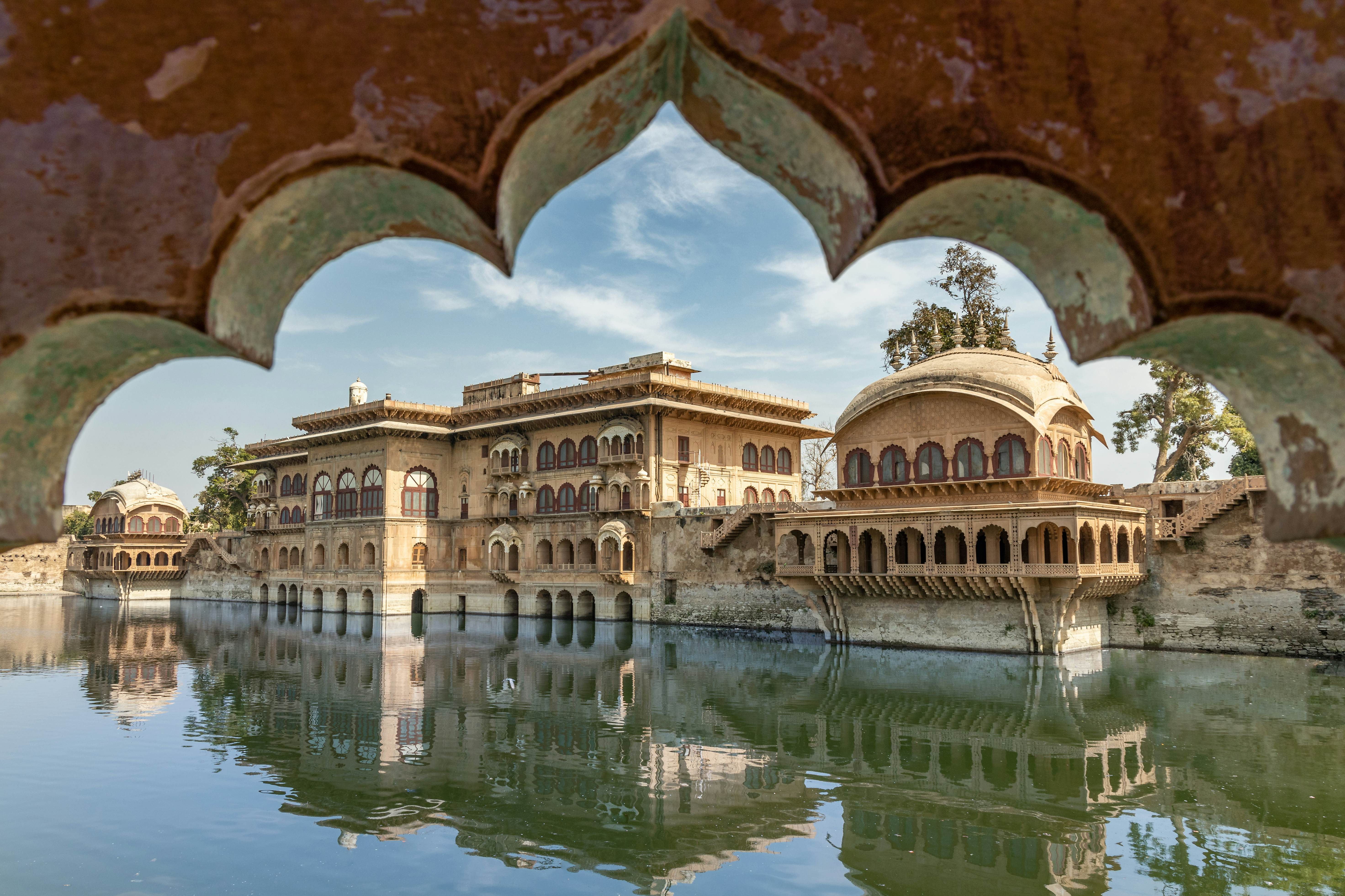 A moat around an elaborate palace building