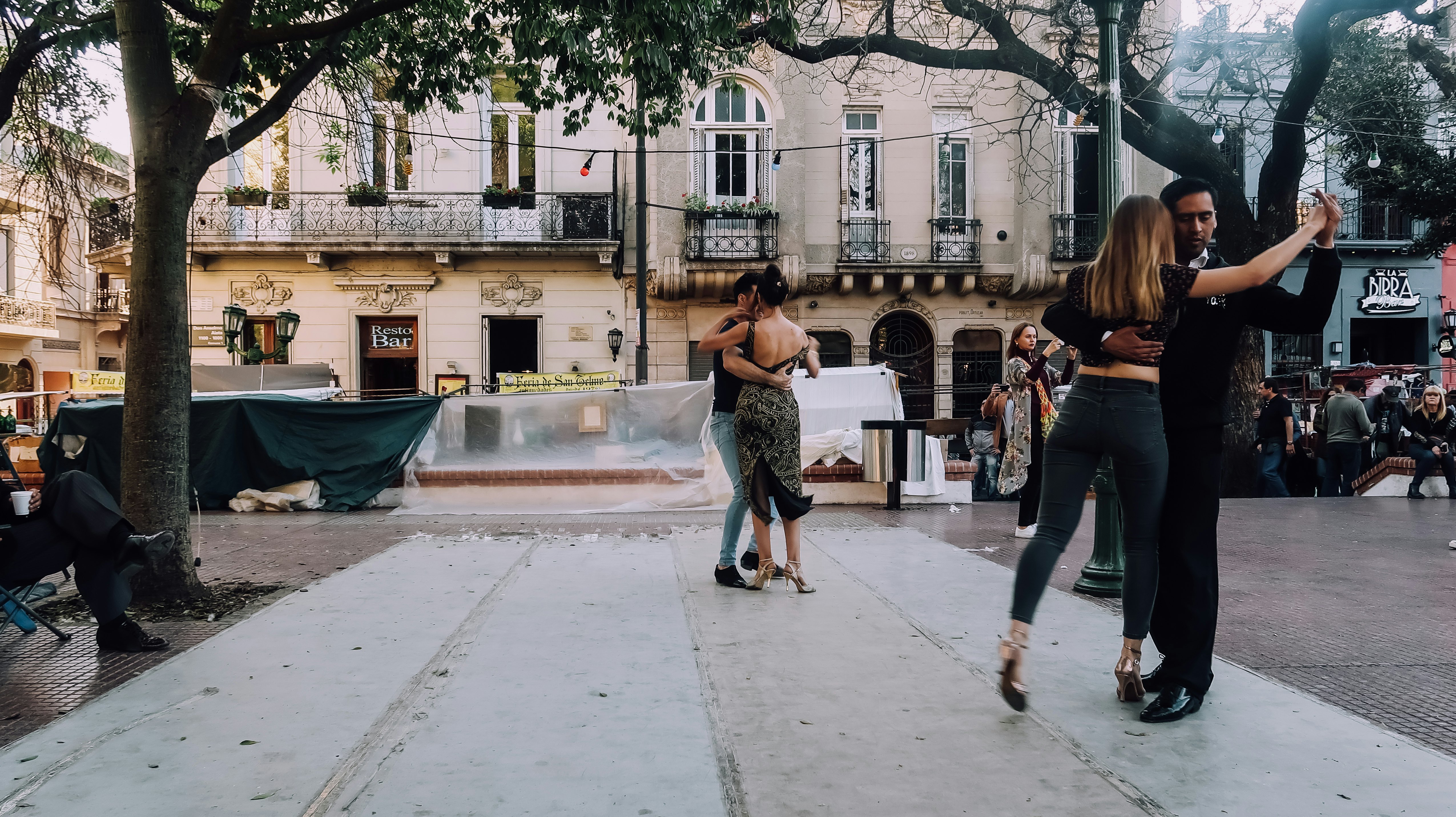 Dancers dance Argentinian tango on the street on a sunday fair in San Telmo old historical neighborhood in the center of Buenos Aires in the evening.