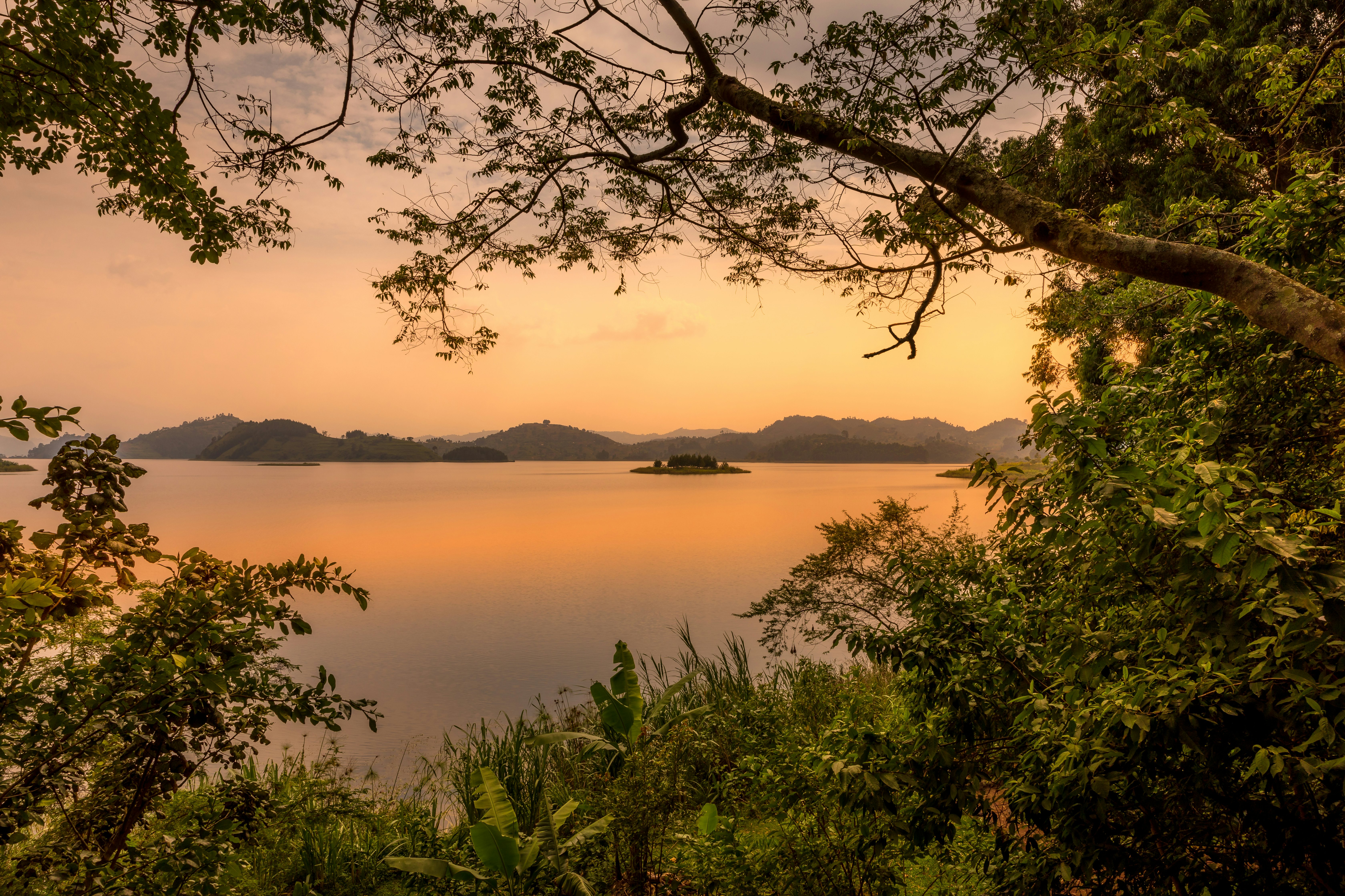 Lake Mutanda at sunset with view on the volcanoes mount Muhavuru and mount Gahinga in East Africa.