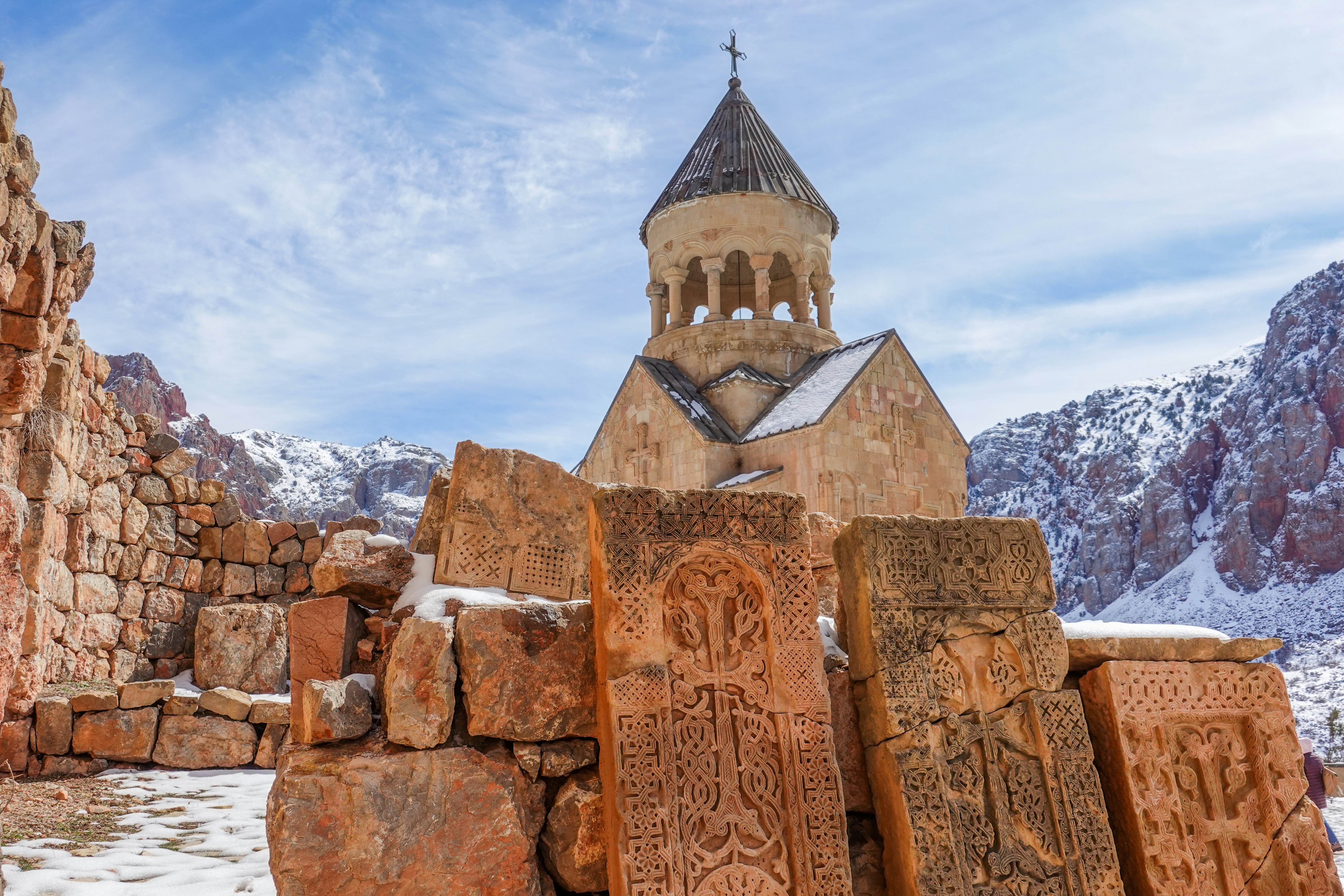 Armenian Khachkars and Surb Astvatsatsin Church in the background, Noravank Monastery - Armenia,