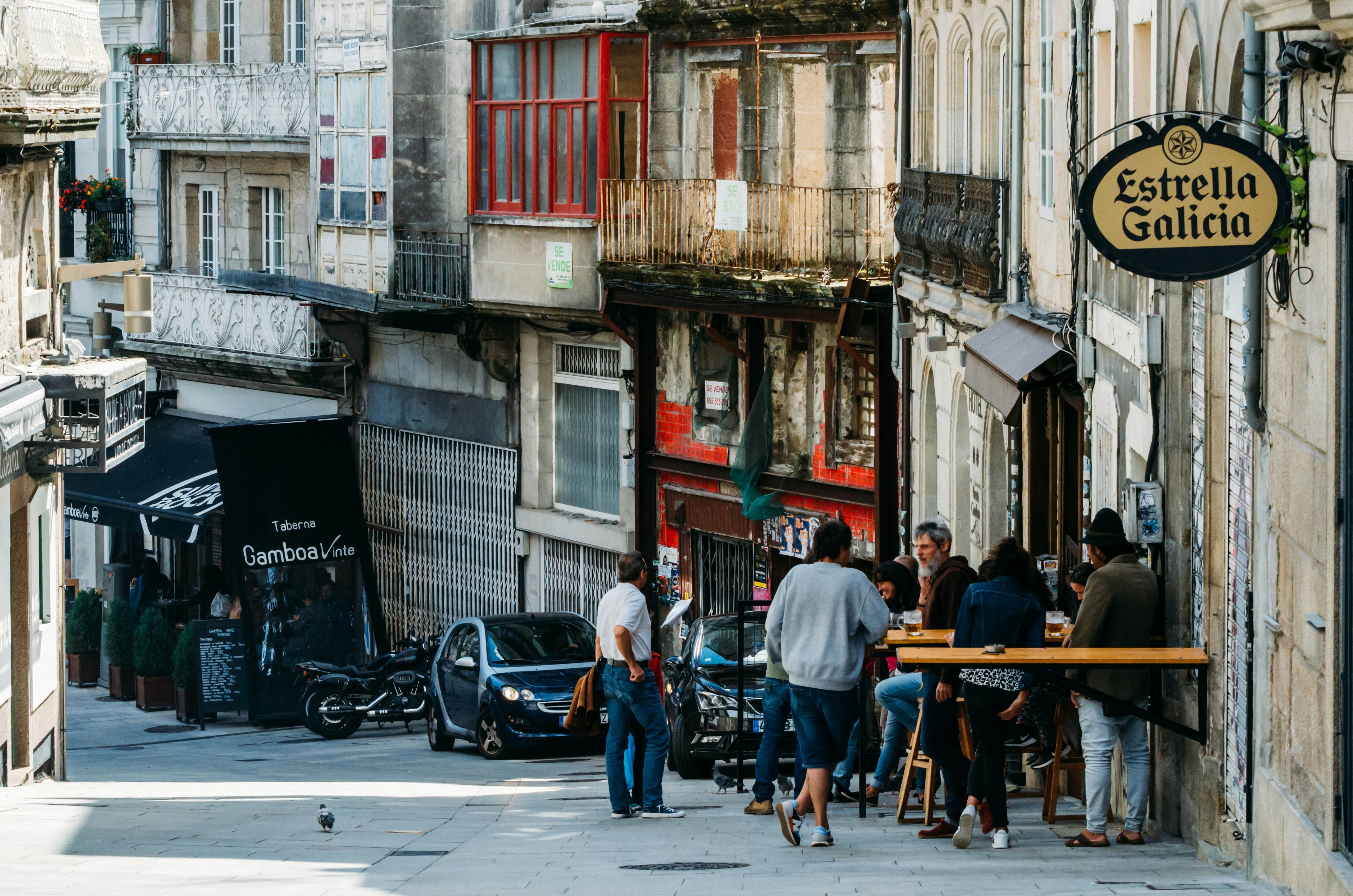 People socialize at a bar terrace in Vigo, Spain