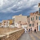 ALGHERO, ITALY - MAY 29, 2023: People walk along the seawall waterfront in rainy weather Alghero town in Sardinia island, Italy.; Shutterstock ID 2396982381; purchase_order: 65050 - Digital Destinations and Articles; job: Lonely Planet Online Editorial; client: Best places in Sardinia; other: Brian Healy
2396982381
alghero, cityscape, cloudy, day, destination, image, island, italian, italian town, italy, landmark, old, old town, people, photo, place, rainy, sardinia, seawall, skyline, street, town, townscape, travel, walls, waterfront, weather
ALGHERO, ITALY - MAY 29, 2023: People walk along the seawall waterfront in rainy weather Alghero town in Sardinia island, Italy