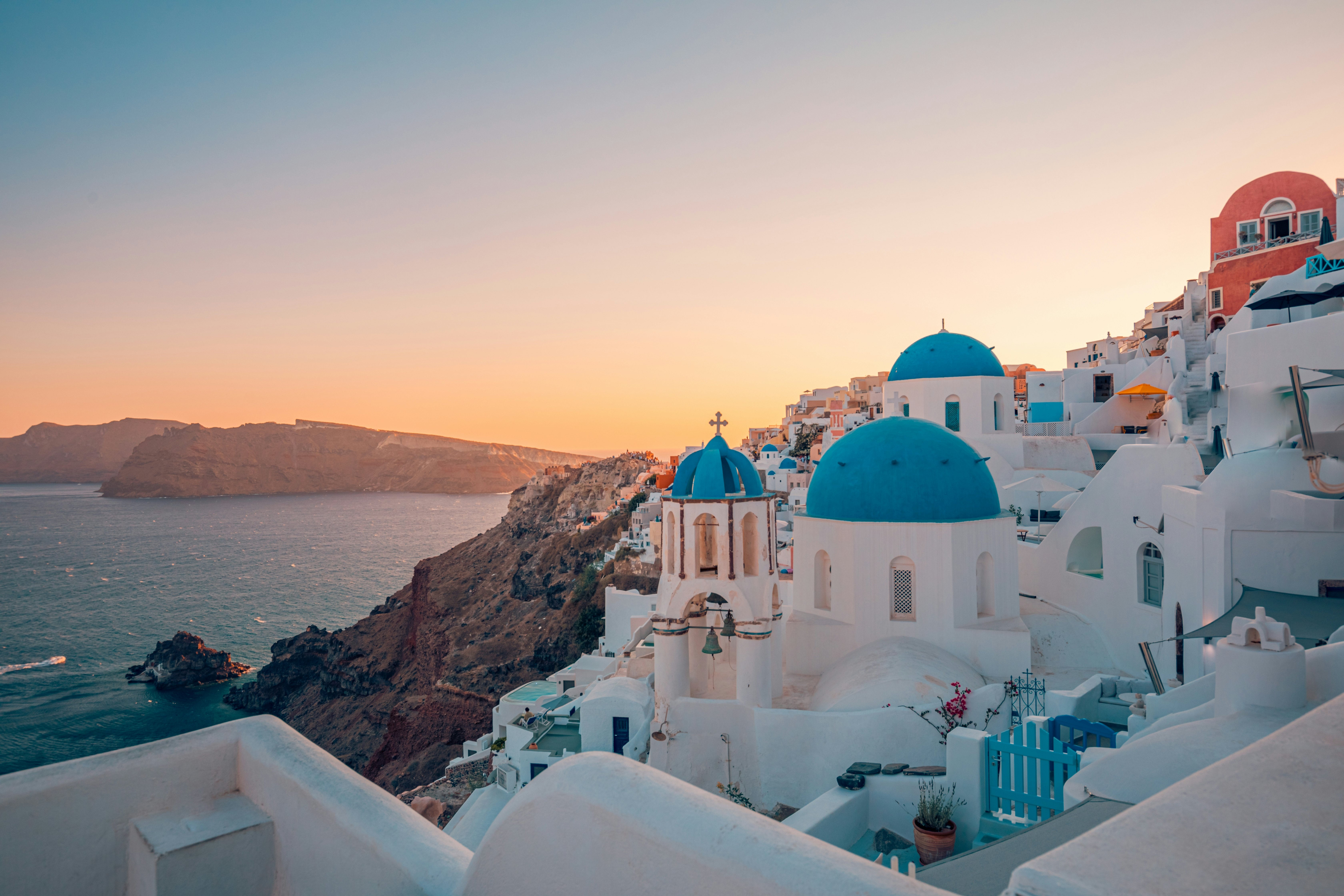 Europe summer destination. Traveling tourism, sunset scenic famous landscape of Santorini island, Oia, Greece. Caldera view, colorful clouds, dream cityscape.