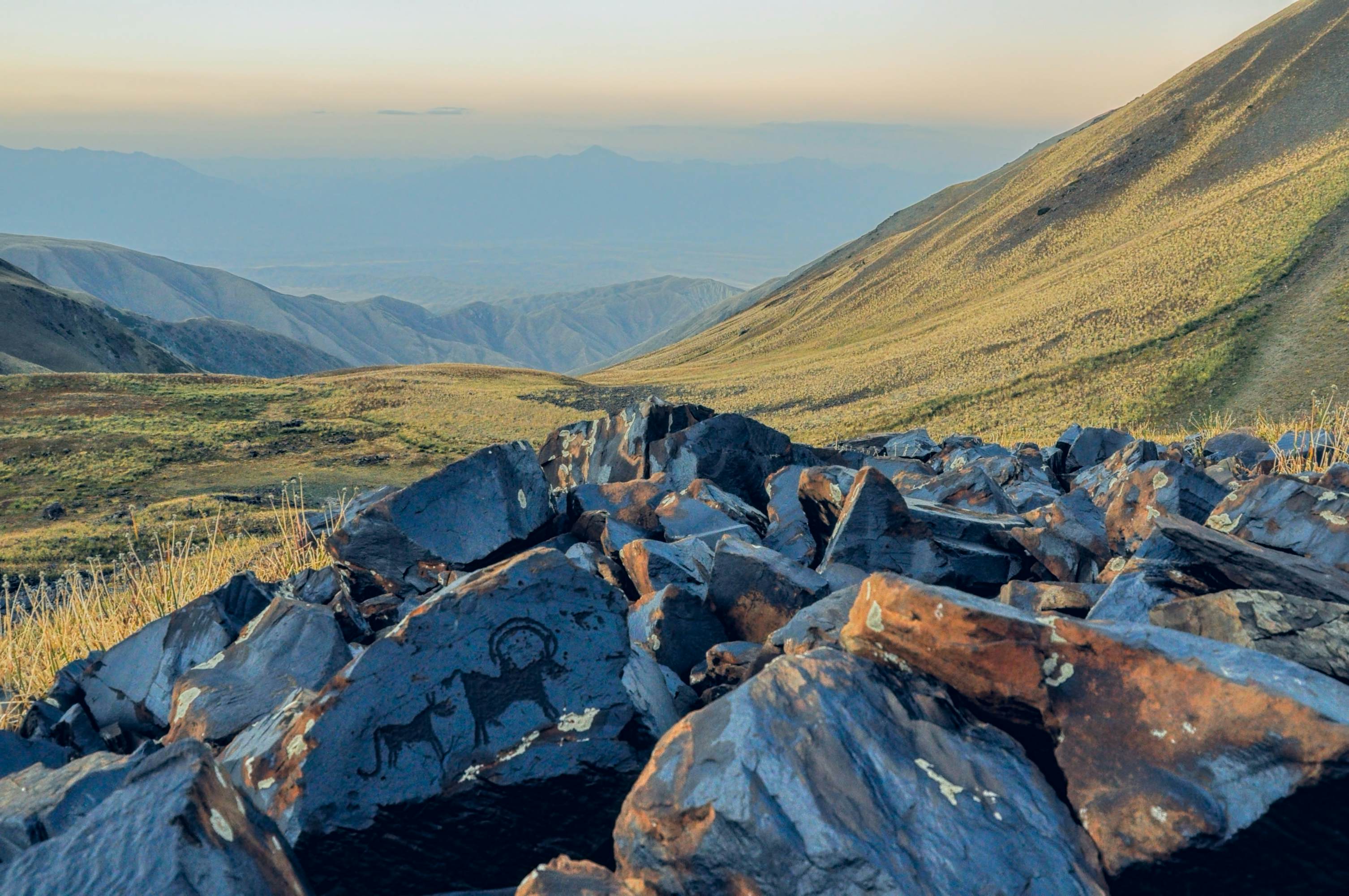 Rocks with pictograms at Saimaluu Tash in Kyrgyzstan