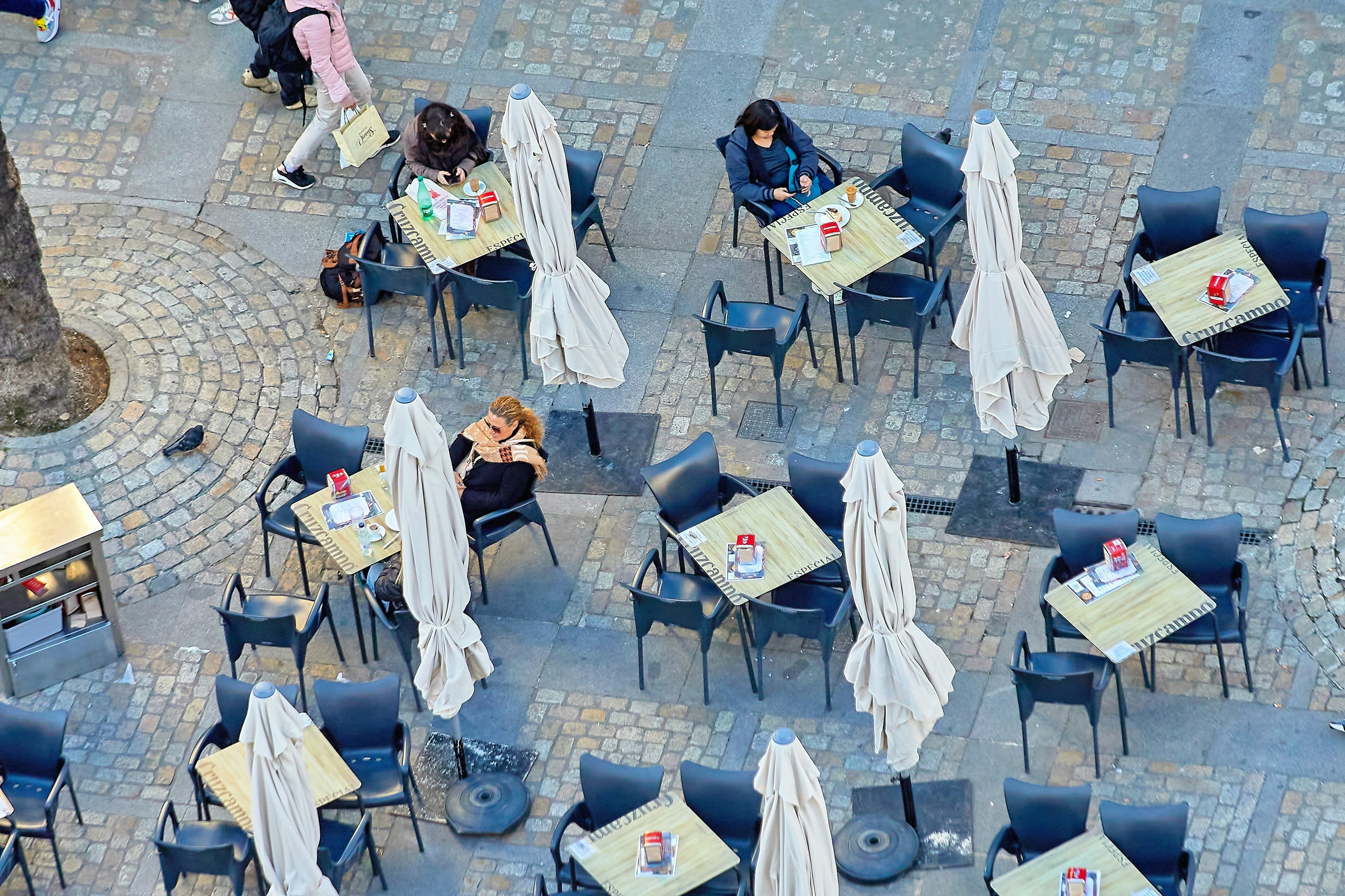 A view over cafe tables in a square in Cadiz, Spain.